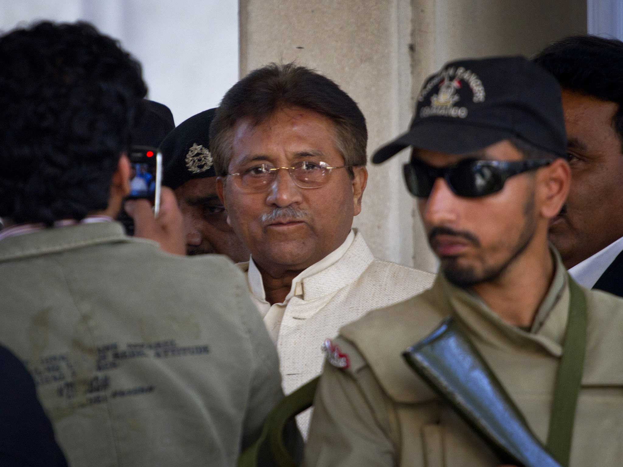 Pakistan's former president and military ruler Pervez Musharraf, centre, leaves court