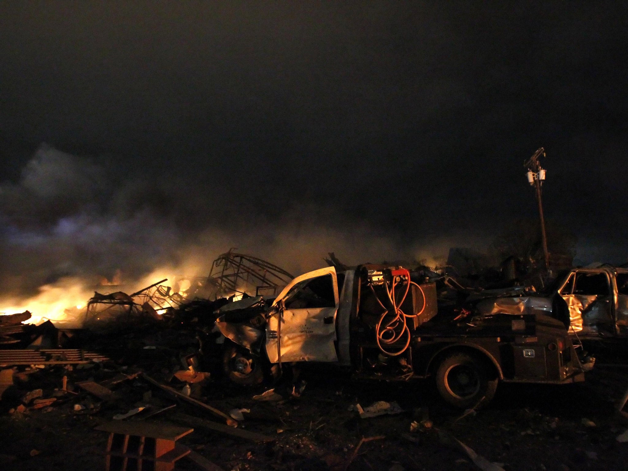 The remains of a fertilizer plant burn after an explosion at the plant in the town of West, near Waco, Texas