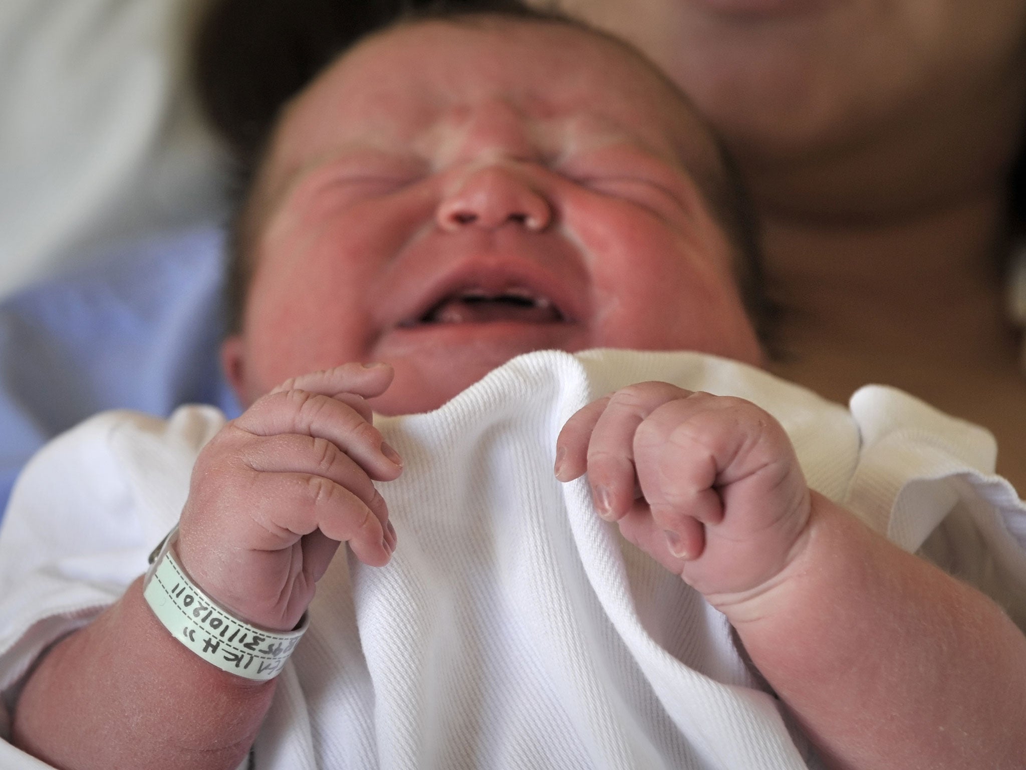 Scientists have found that picking up and cuddling a baby really does help them to calm down