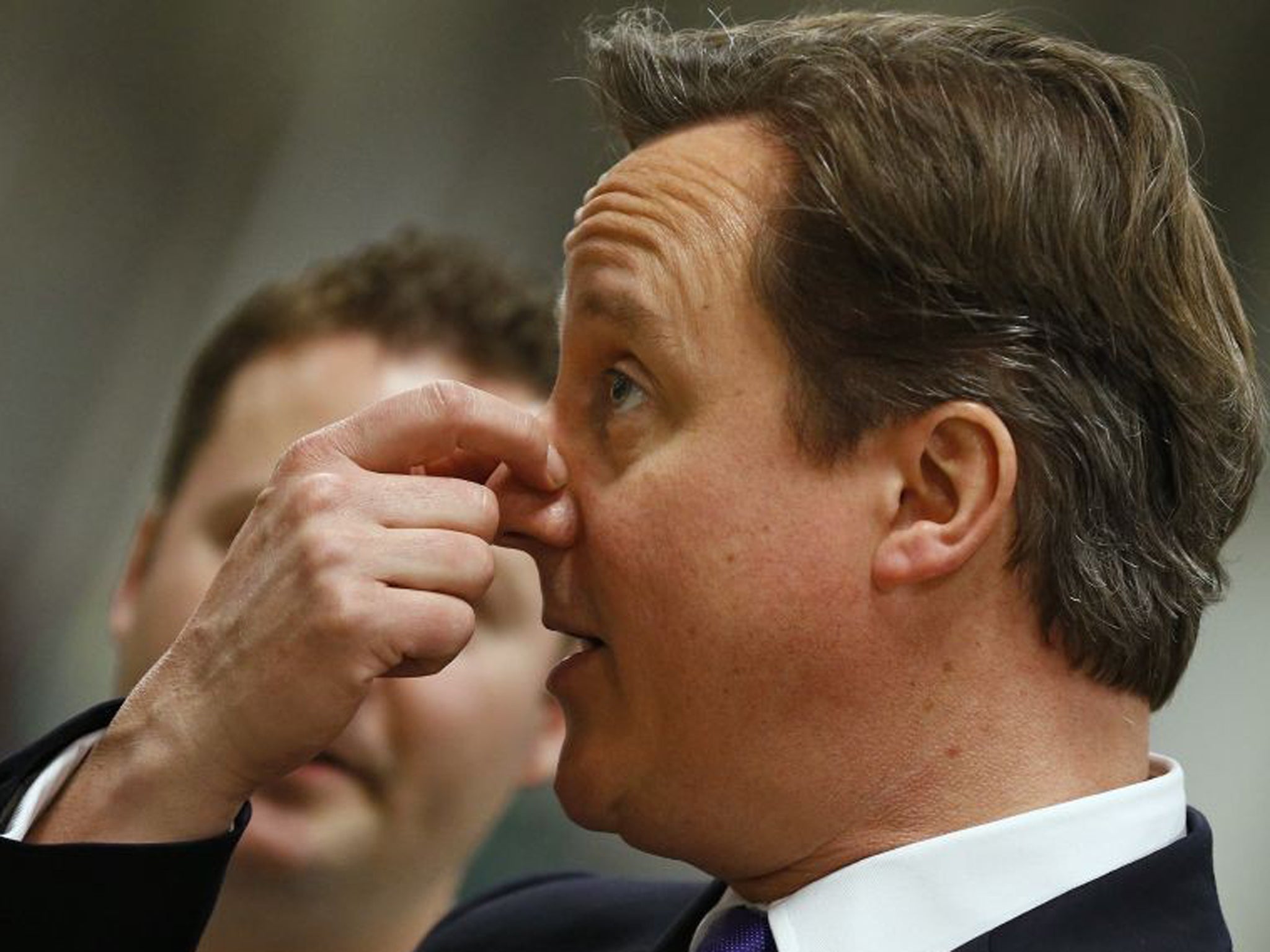 David Cameron speaks with workers during his visit to the Ocado distribution centre near Nuneaton