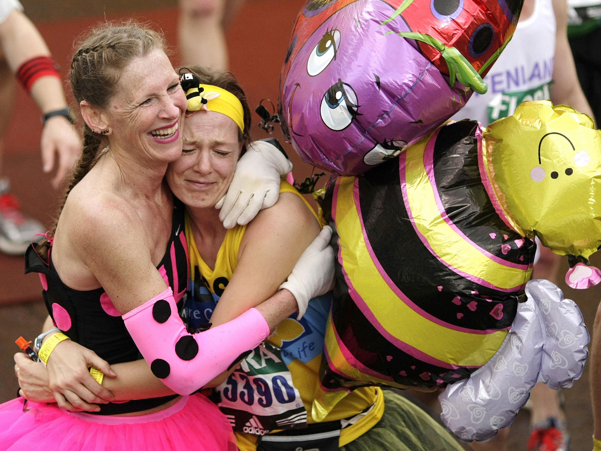 Fun runners celebrate finishing a gruelling Flora London Marathon in 2008