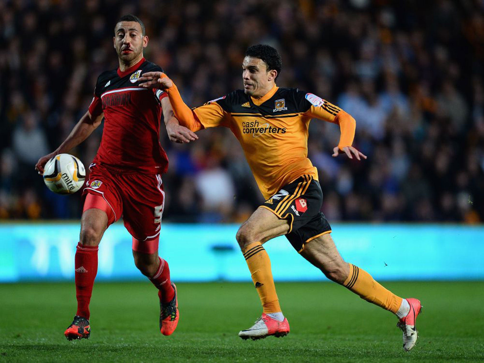 Hull’s Gedo (right) challenges Lewin Nyatanga last night