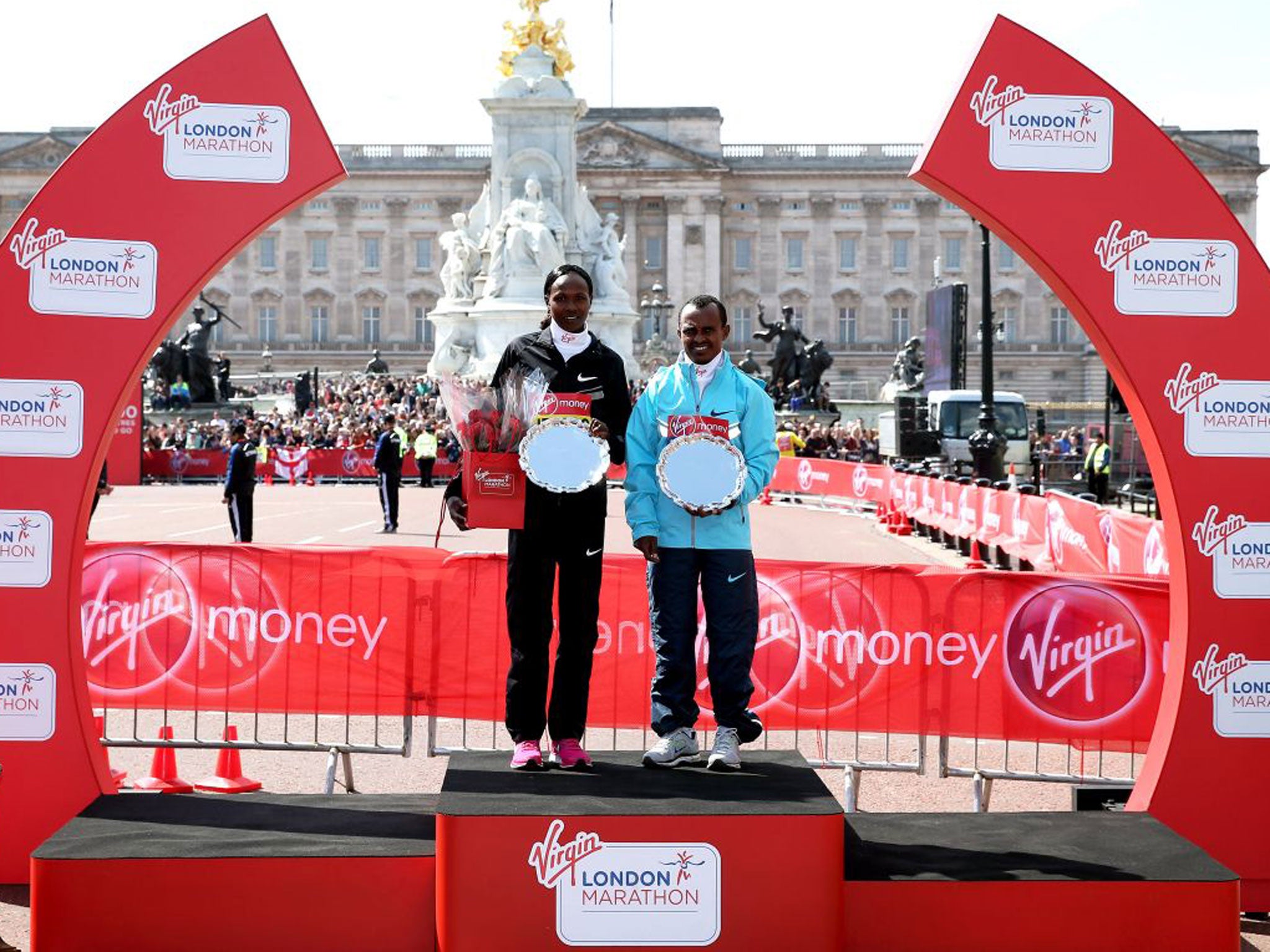 Elite Race winners Priscah Jeptoo of Kenya and Tsegaye Kebede of Ethiopia celebrate