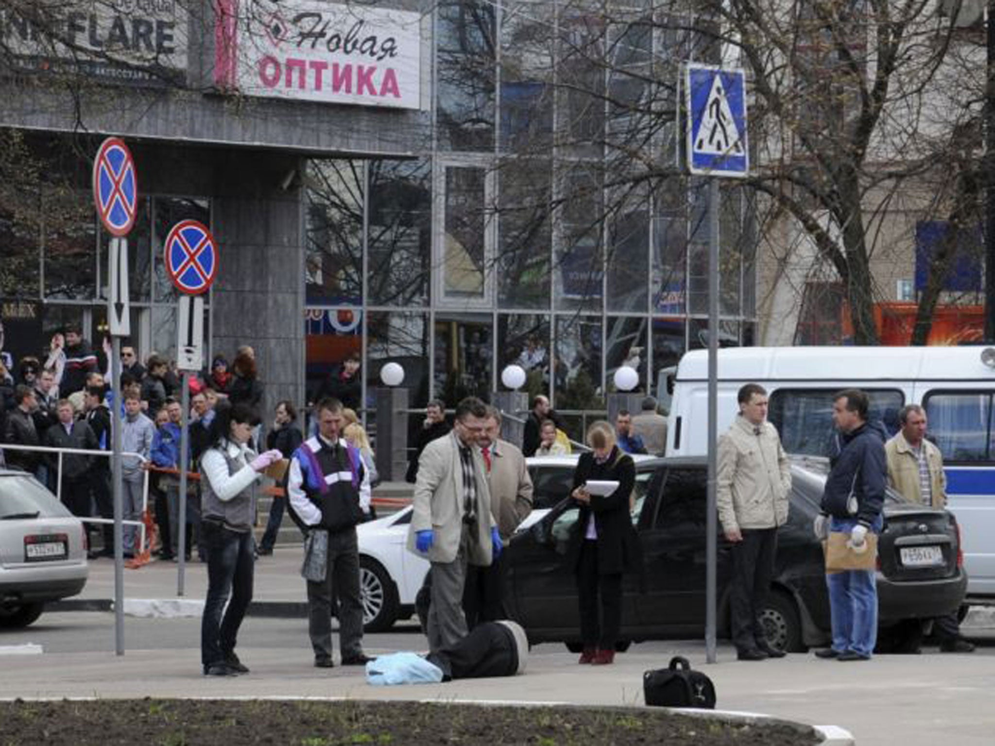 Investigators inspect the body of a victim killed by a gunman in Belgorod. A gunman shot dead five people in the western Russian city before speeding away in a car, local police said.