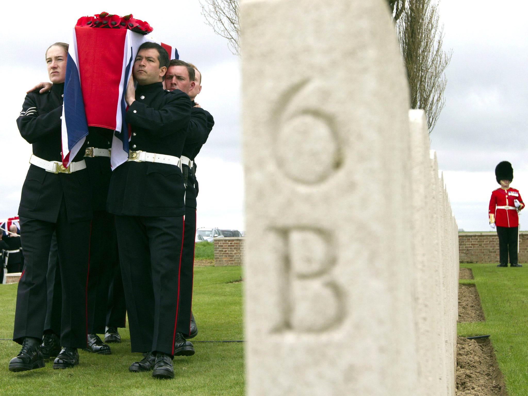 Soldiers carry the casket of a World War One soldier during a ceremony at the H.A.C. cemetery in Ecoust-St-Mein, France