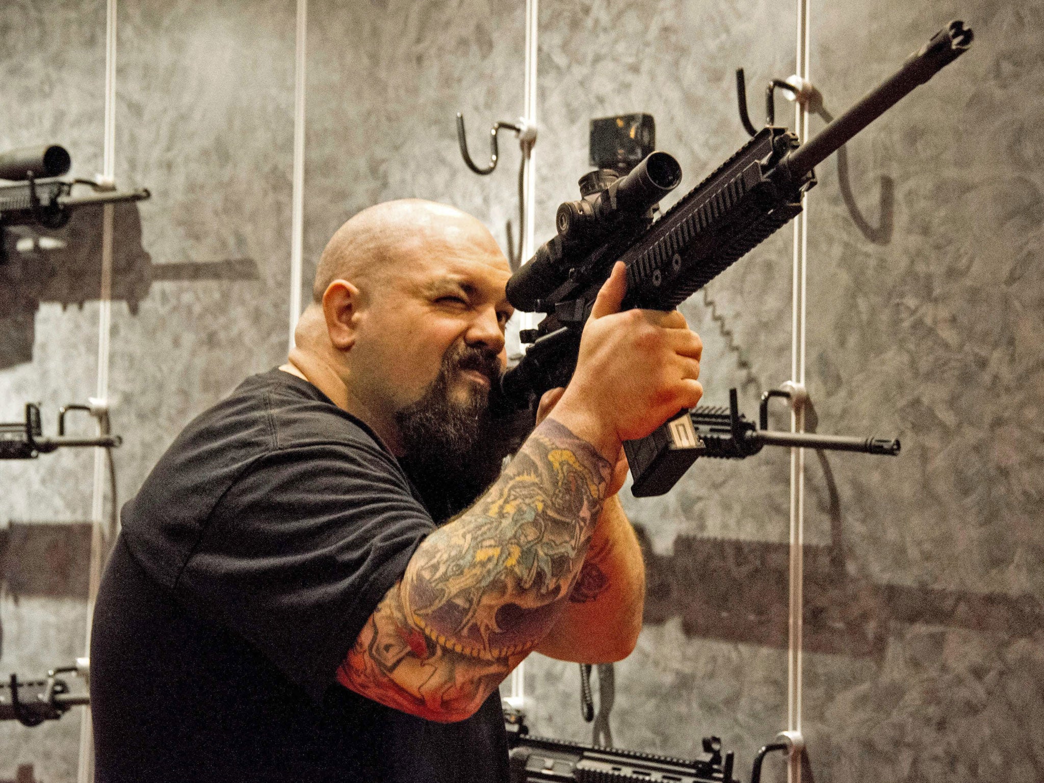 A man hefts and aims a H&K (Heckler and Koch) MR762A1 rifle fitted with a scope at the National Rifle Association (NRA) Annual Meetings and Exhibits on April 14, 2012 in St. Louis, Missouri.