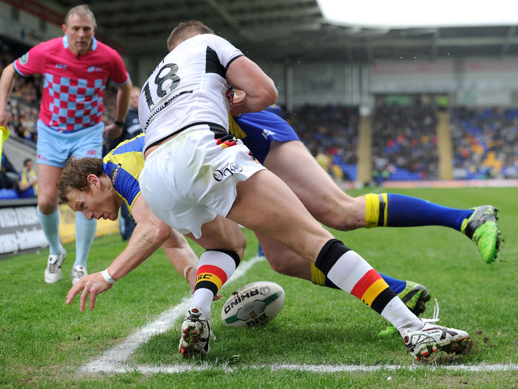 Warrington Wolves' Joel Monaghan goes over for a try past Bradford Bulls Michael Platt during the Super League match at the Halliwell Jones Stadium, Warrington