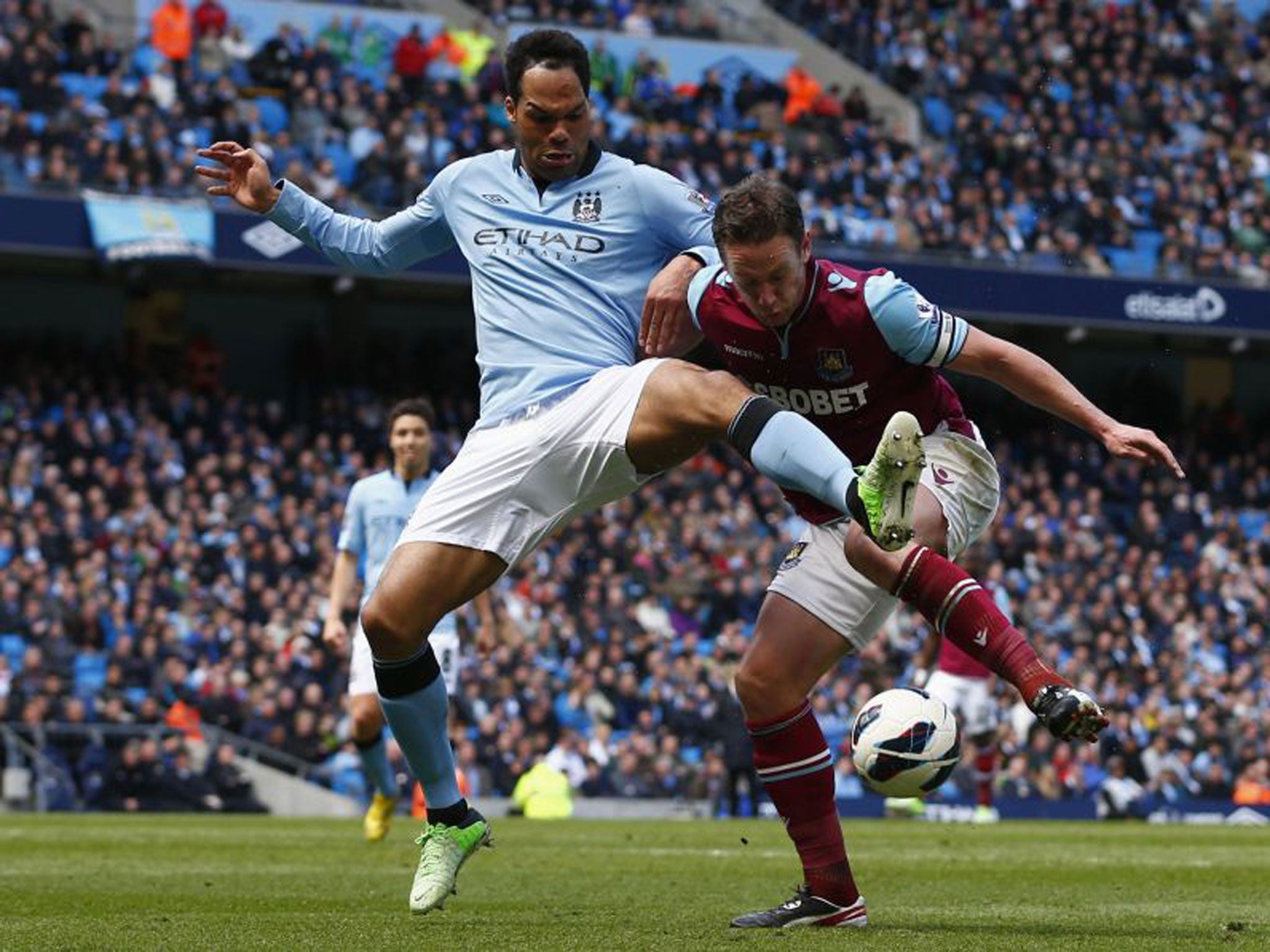 Joleon Lescott and Kevin Nolan battle for possession