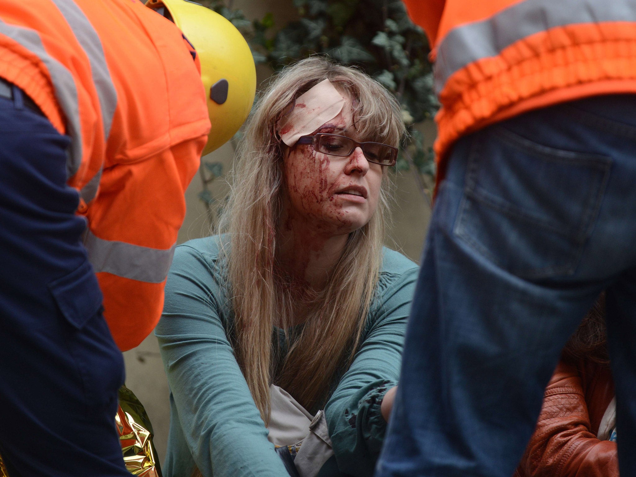 Rescue workers take care of woman injured by a powerful gas blast in Prague