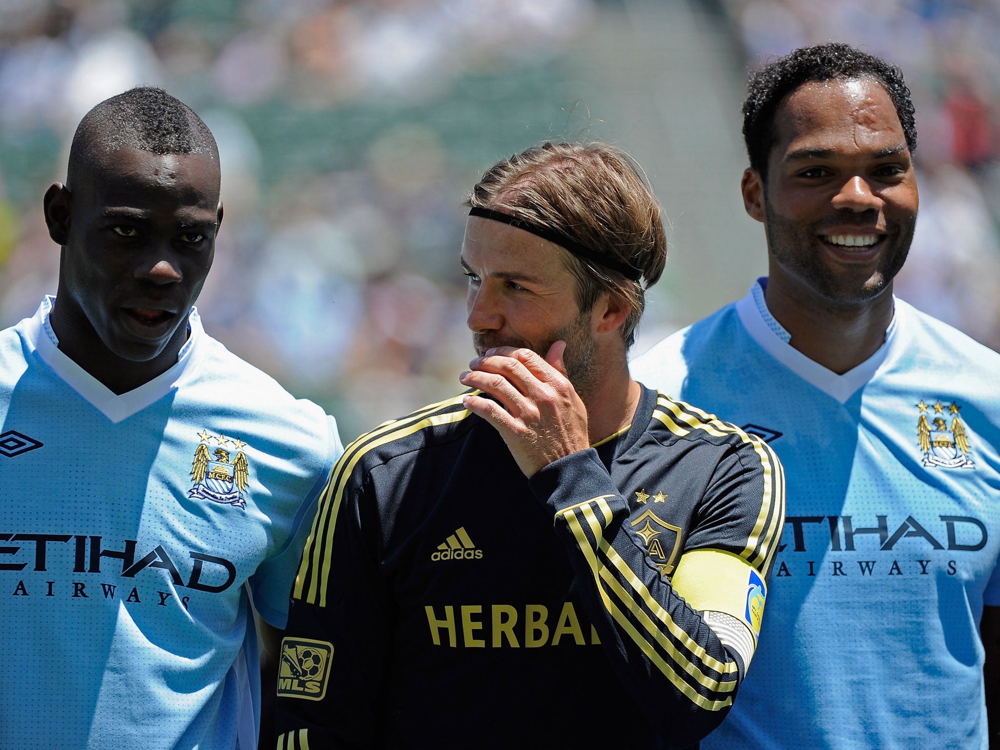 City’s Mario Balotelli (left) and Joleon Lescott with David Beckham (centre), then of LA Galaxy, in 2011