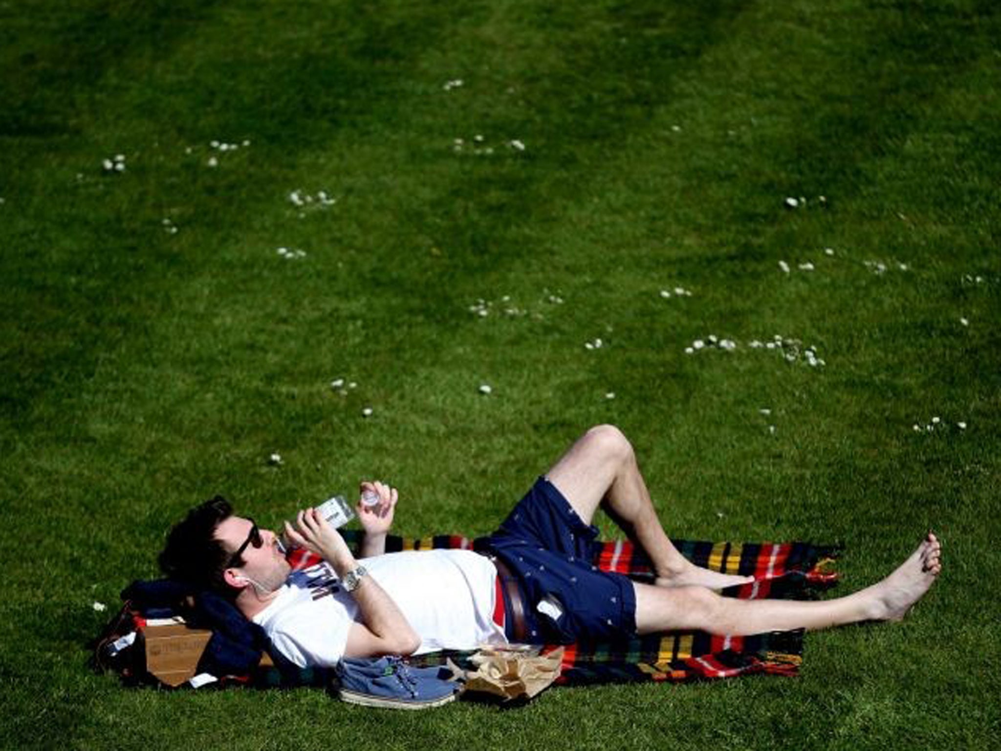 A man soaks up the recent sunshine in Bath