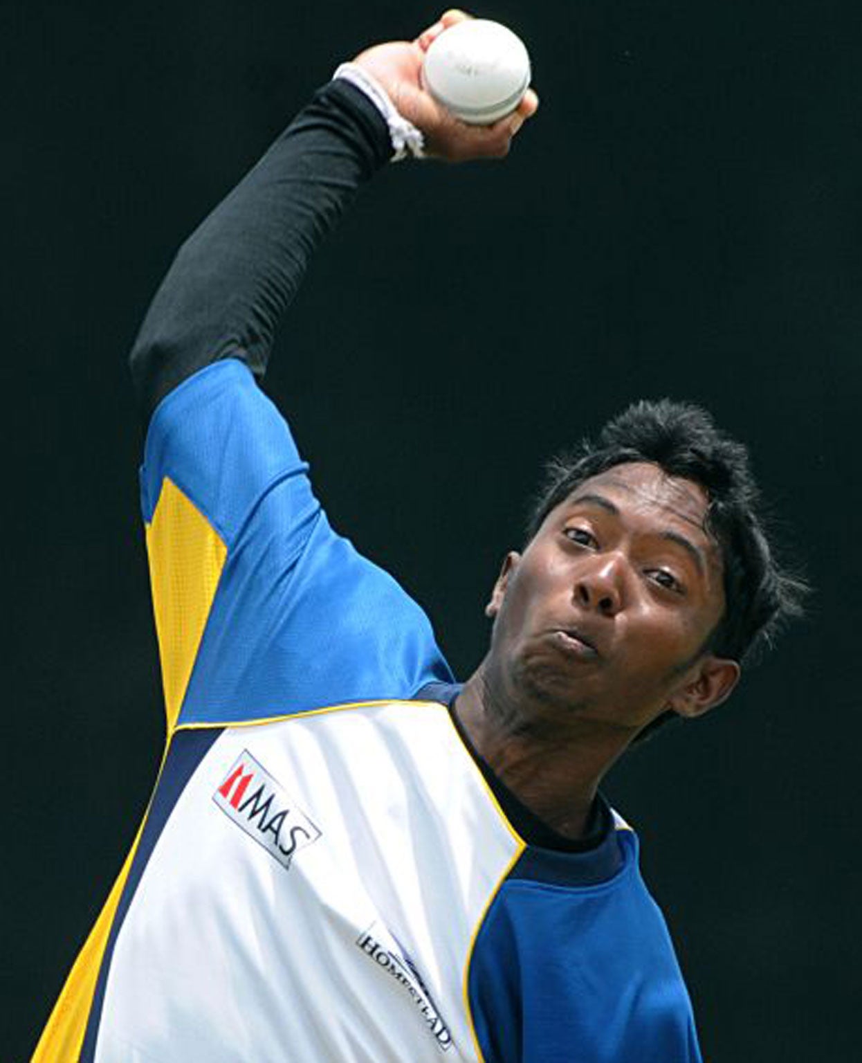 Sri Lanka cricketer Akila Dananjaya bowls during a practice session at the Suriyawewa Mahinda Rajapakse International Cricket Stadium in the southern district of Hambantota