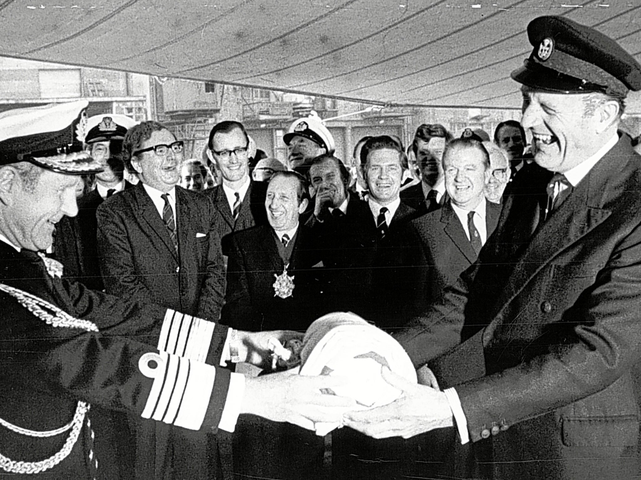 First Sea Lord Sir Michael Pollock, left, hands over the White Ensign to Morgan-Giles in 1971