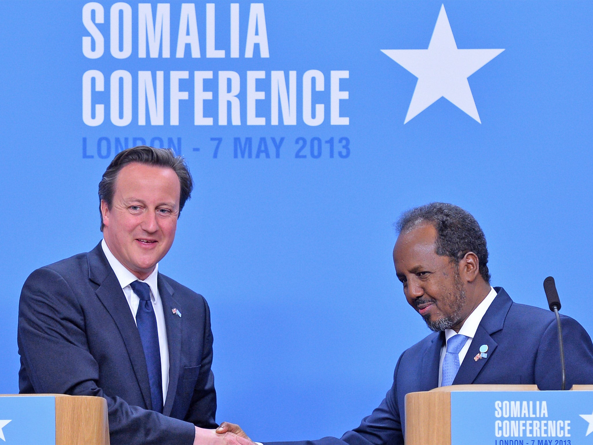 Prime Minister David Cameron shakes hands with Somali President Hassan Sheikh Mohamud