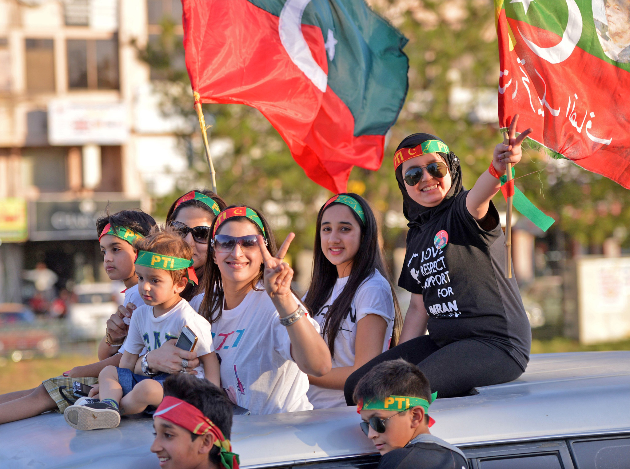 Supporters of Imran Khan flash victory signs, main image; the retired cricketer following his fall on Tuesday
