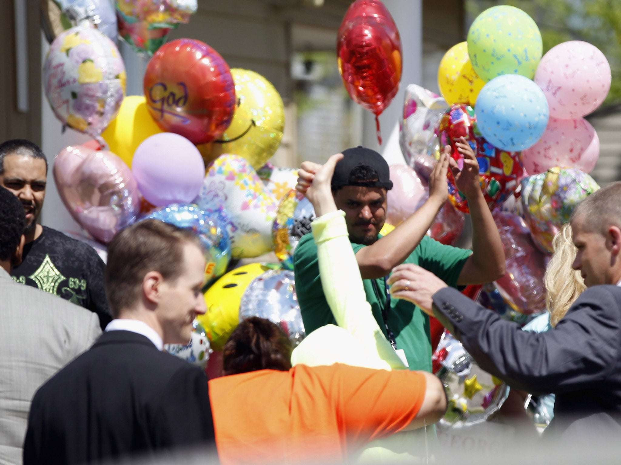 Kidnap victim Gina DeJesus gives a thumbs up after arriving home with family members. Gina DeJesus was one of three women who was held captive for almost a decade in a home in Cleveland, Ohio.