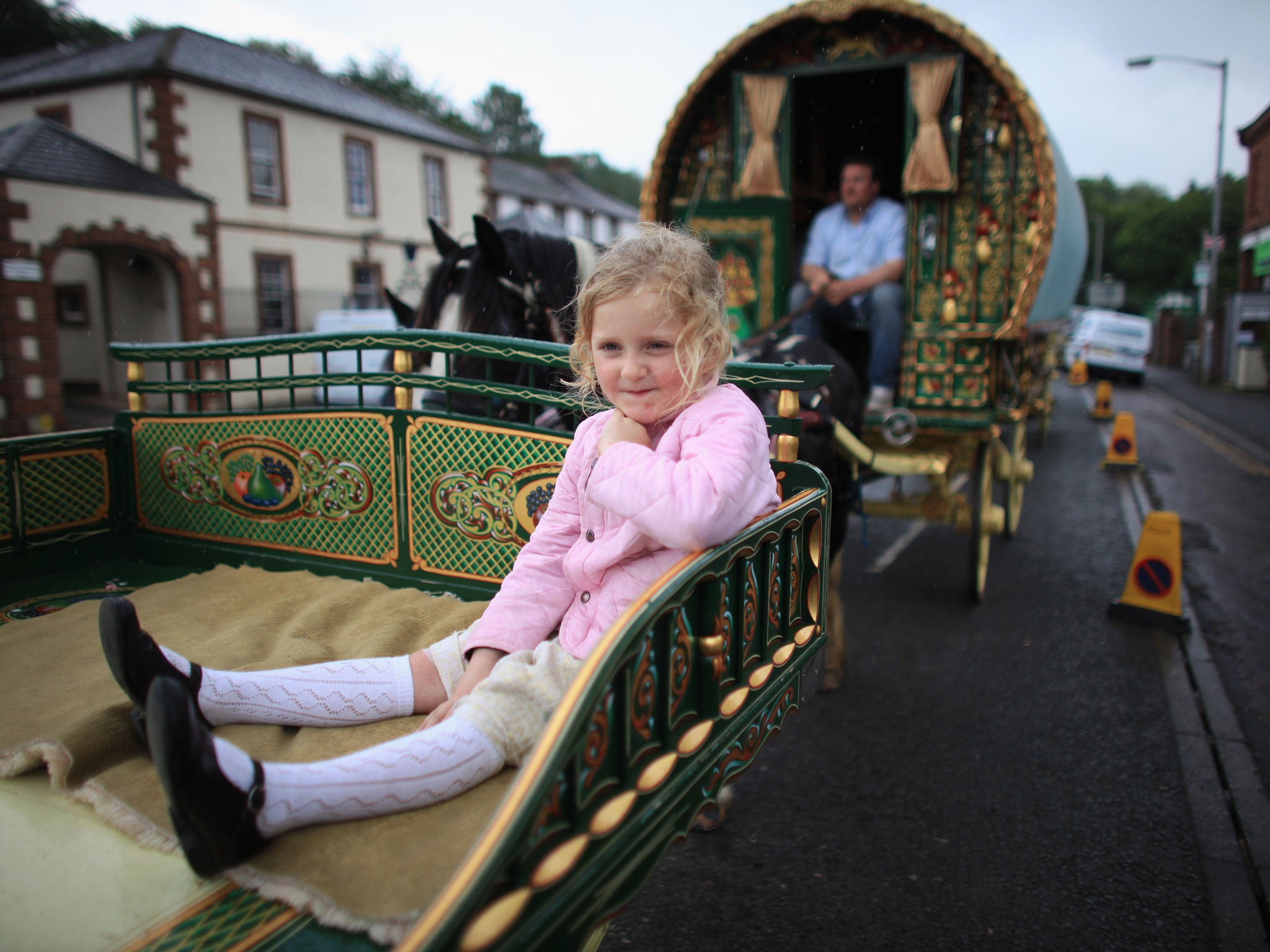 Traveller girl Mary Nicholson, aged six, arrives on her family's Romany Caravan at the Appleby Horse Fair on June 7, 2012 in Appleby, England. Appleby Horse Fair has existed under the protection of a charter granted by James II since 1685. It is one of th