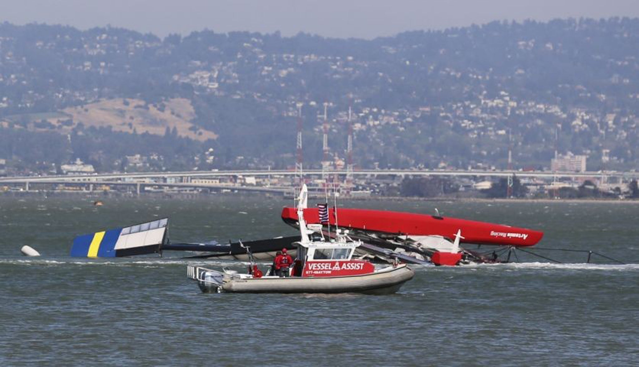 The Artemis Racing yacht is towed to shore after capsizing in the San Francisco Bay. British yacht-racing champion Andrew "Bart" Simpson, who won a gold medal at the 2008 Summer Olympics in Beijing, was killed when the vessel capsized during training for