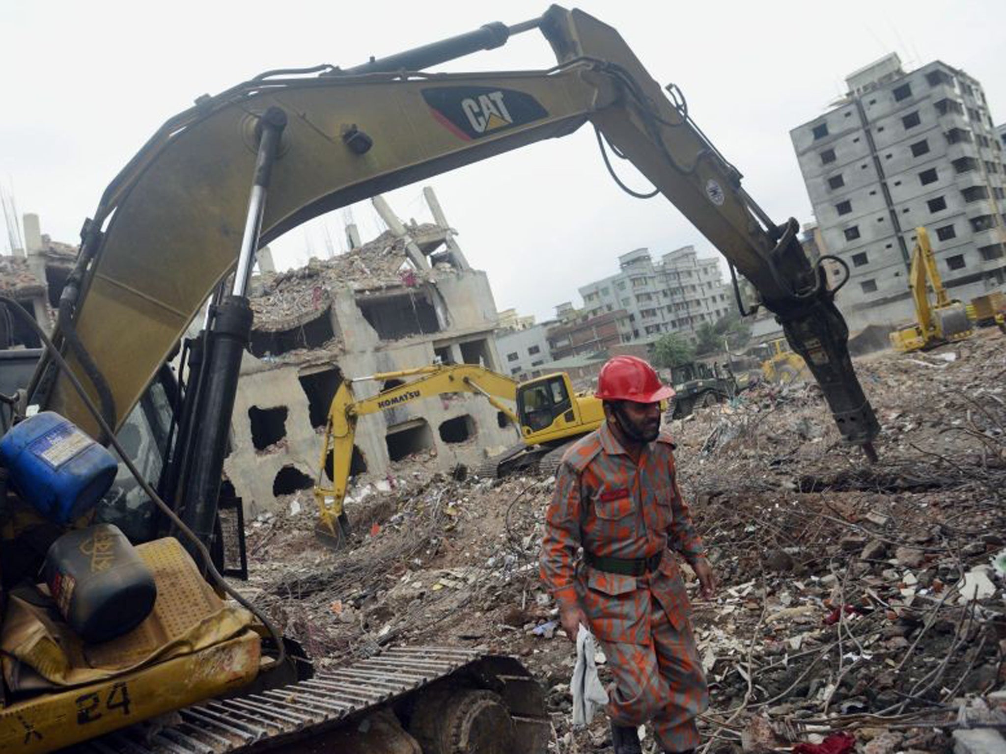 Workers search the wreckage after the Dhaka factory collapse earlier this year