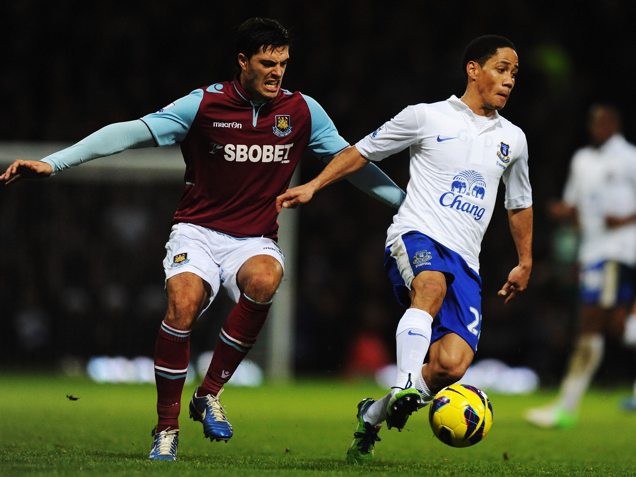 Steven Pienaar (R) of Everton holds off the challenge of James Tompkins (L) of West Ham United