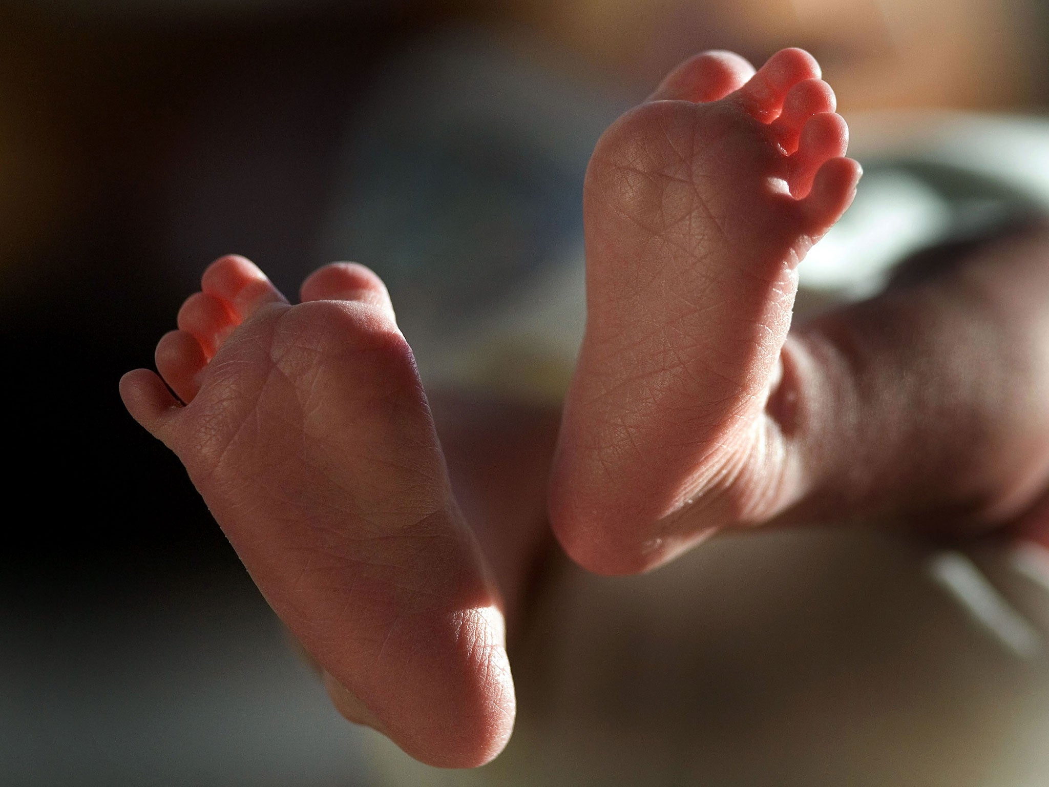 In this file photograph taken on March 20, 2007, a two-week-old boy finds his feet in his new world.