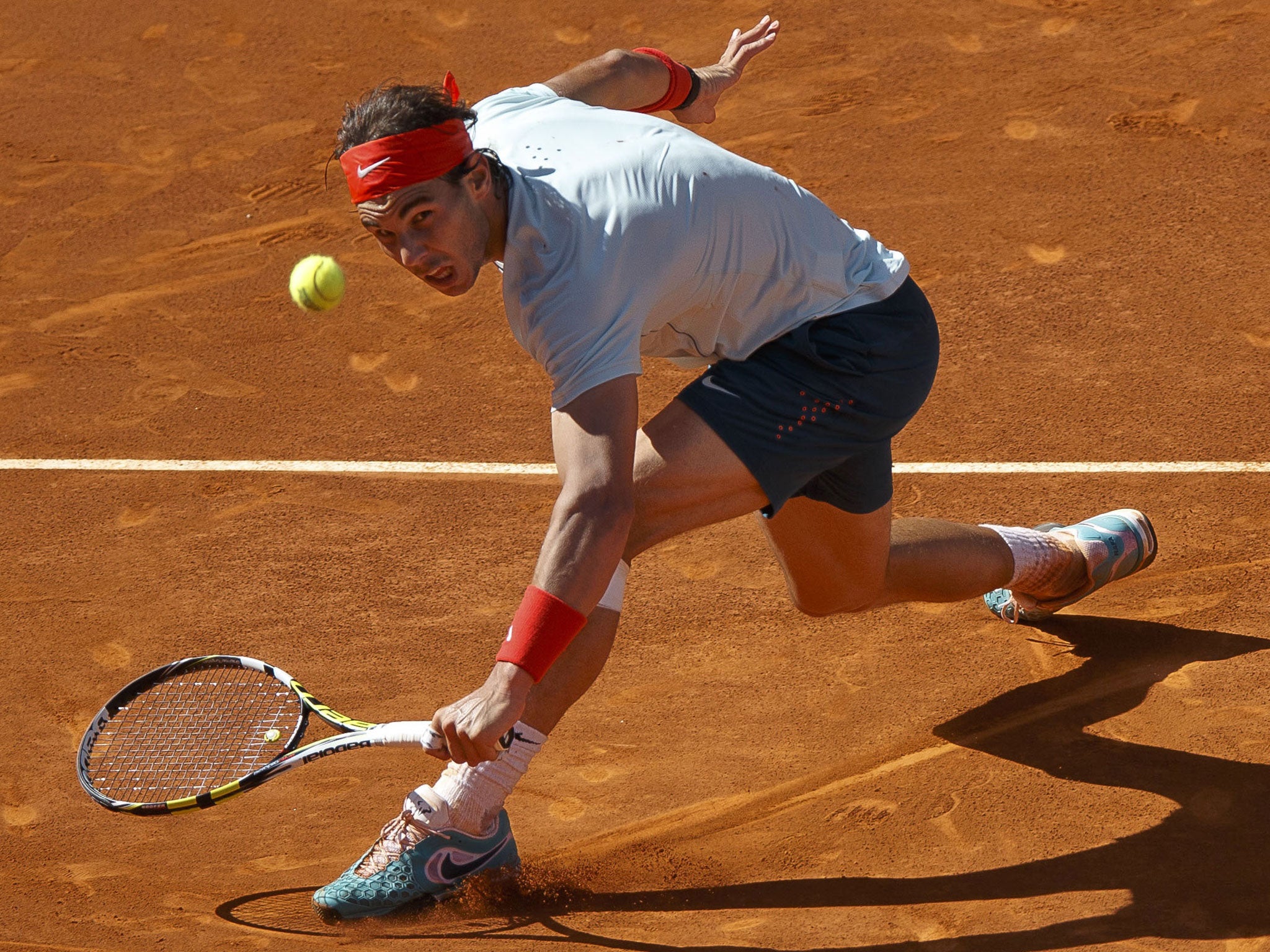 Rafael Nadal reaches to volley a return to David Ferrer