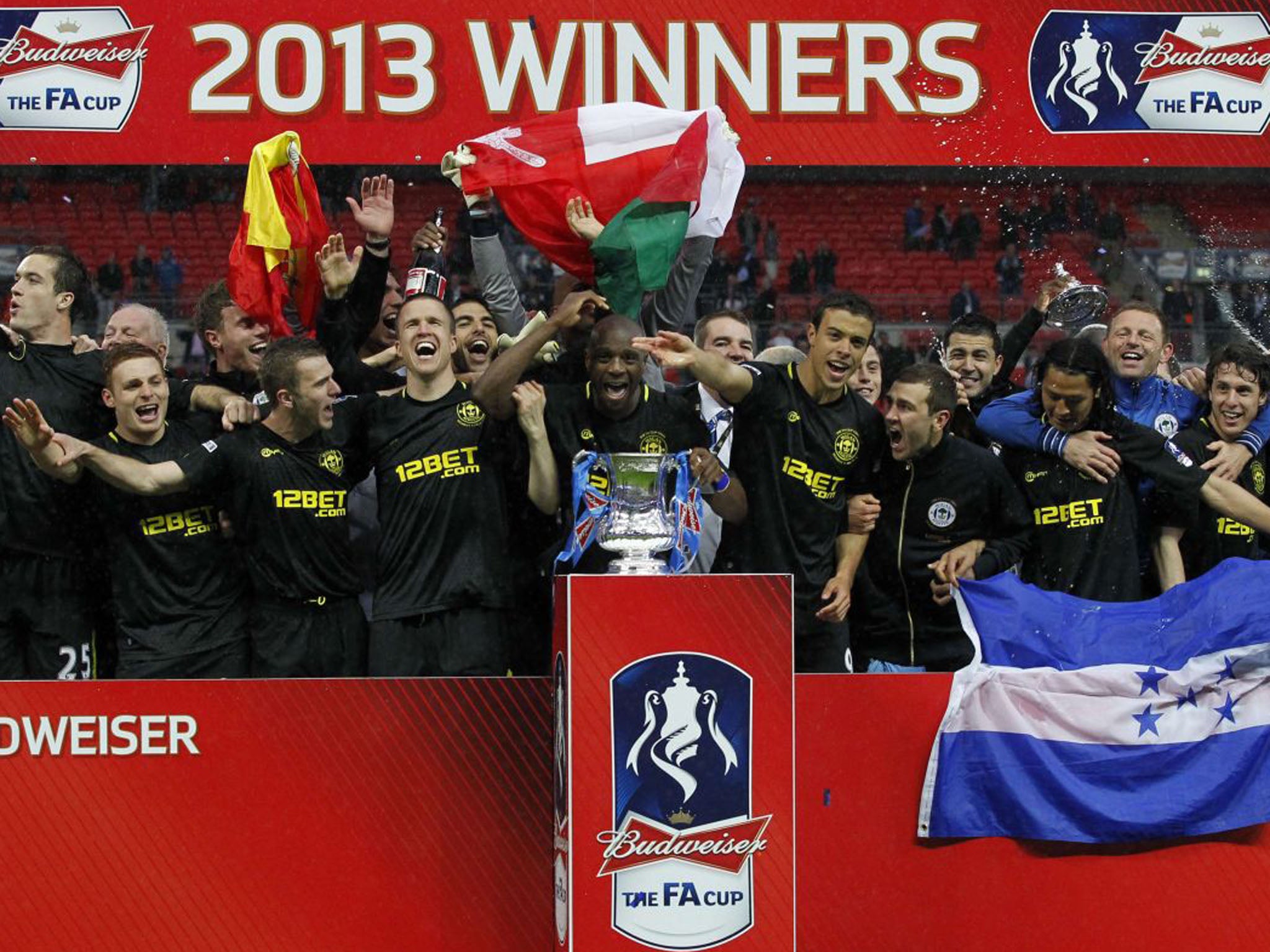 The Wigan team celebrate with the FA Cup (Ian Kingston/AFP/Getty Images)