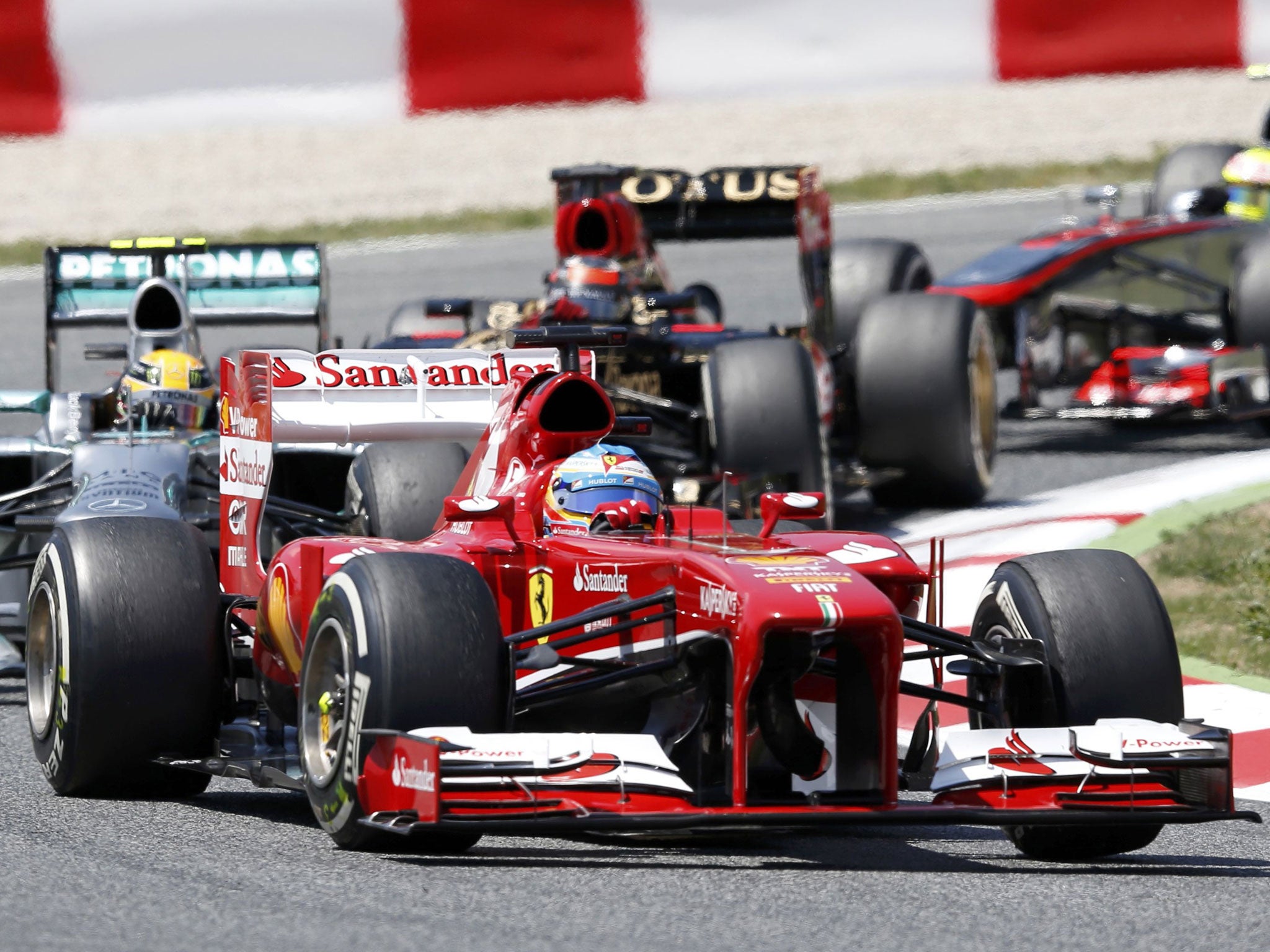 Fernando Alonso gets ahead of Lewis Hamilton on the first lap