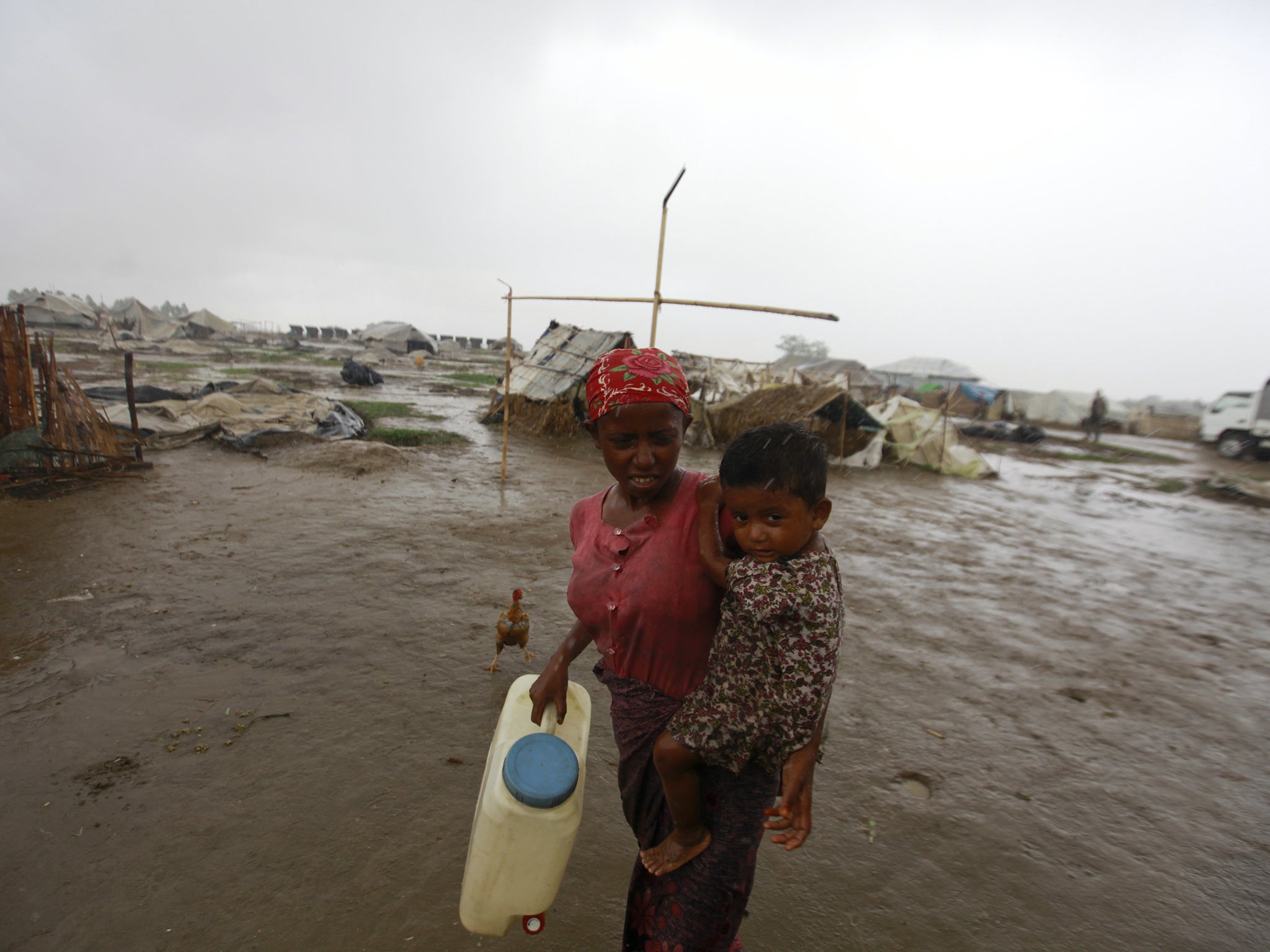 A mother, who chose not to leave for a safer place from Cyclone Mahasen, is pictured with her child at a Rohingya internally displaced persons camp outside of Sittwe, Burma