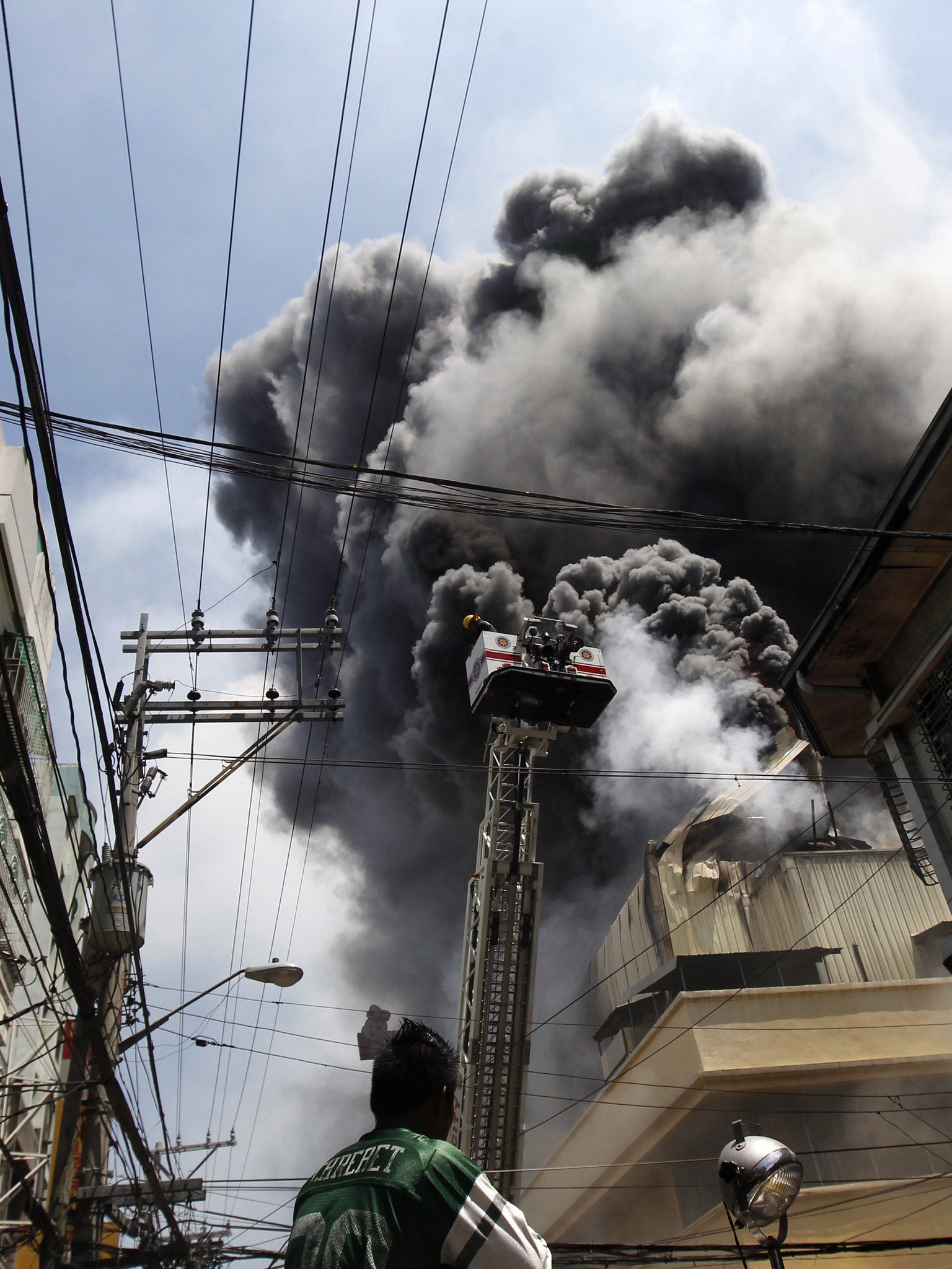Firefighters tackle the blaze at the Divisoria Mall in Manila, Philippines