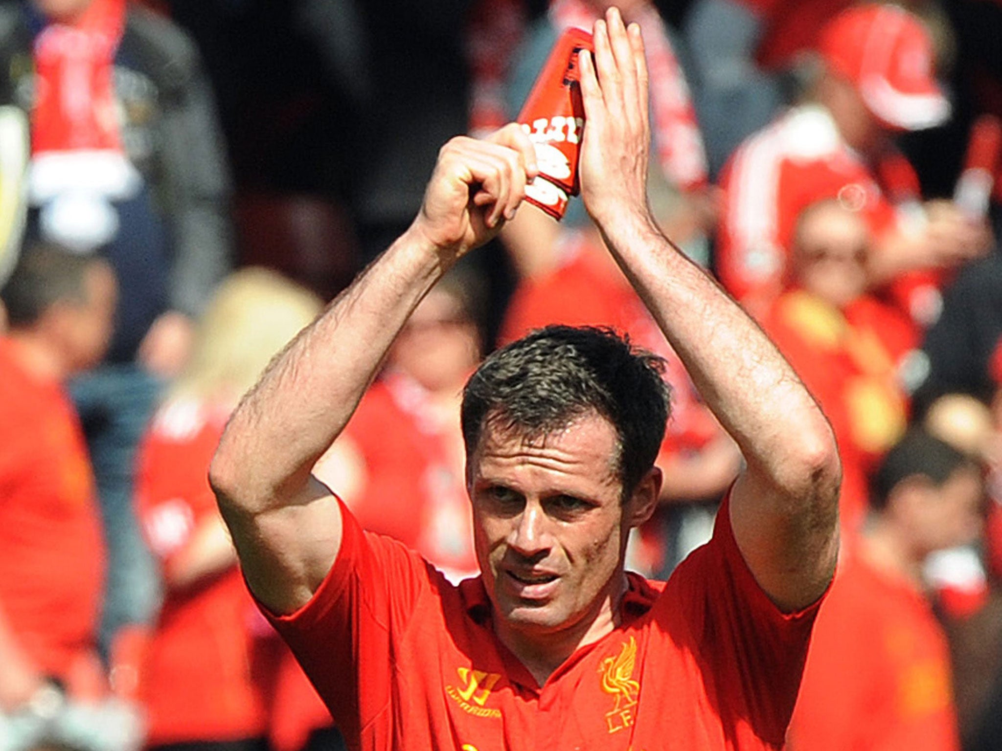 Liverpool's Jamie Carragher applauds at the end of the English Premier League match between Liverpool and Everton at Anfield