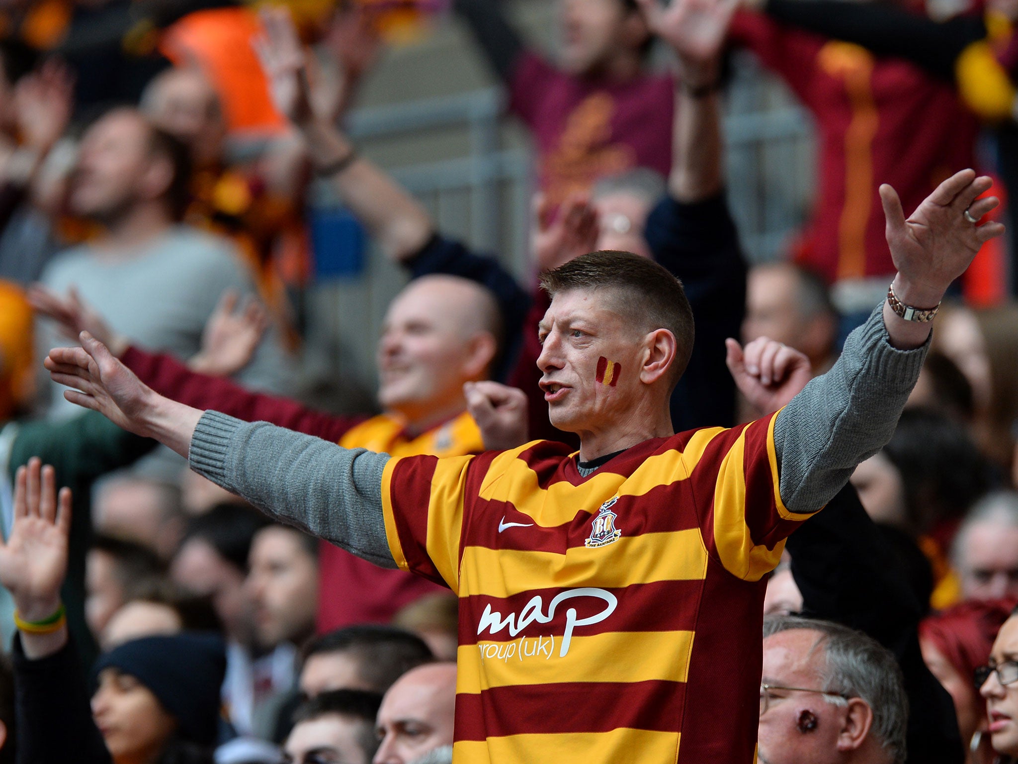 A Bradford fan watches as his team goes on to get promoted