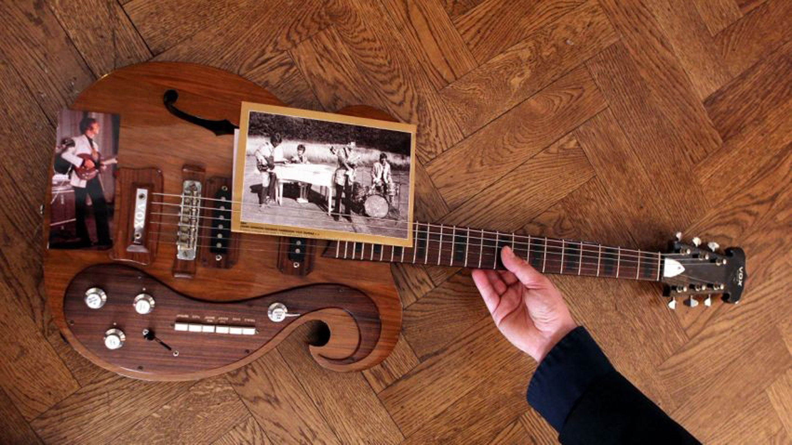 A guitar played by Beatles pair John Lennon and George Harrison which sold for 408,000 US dollars (£269,000) at a New York auction today