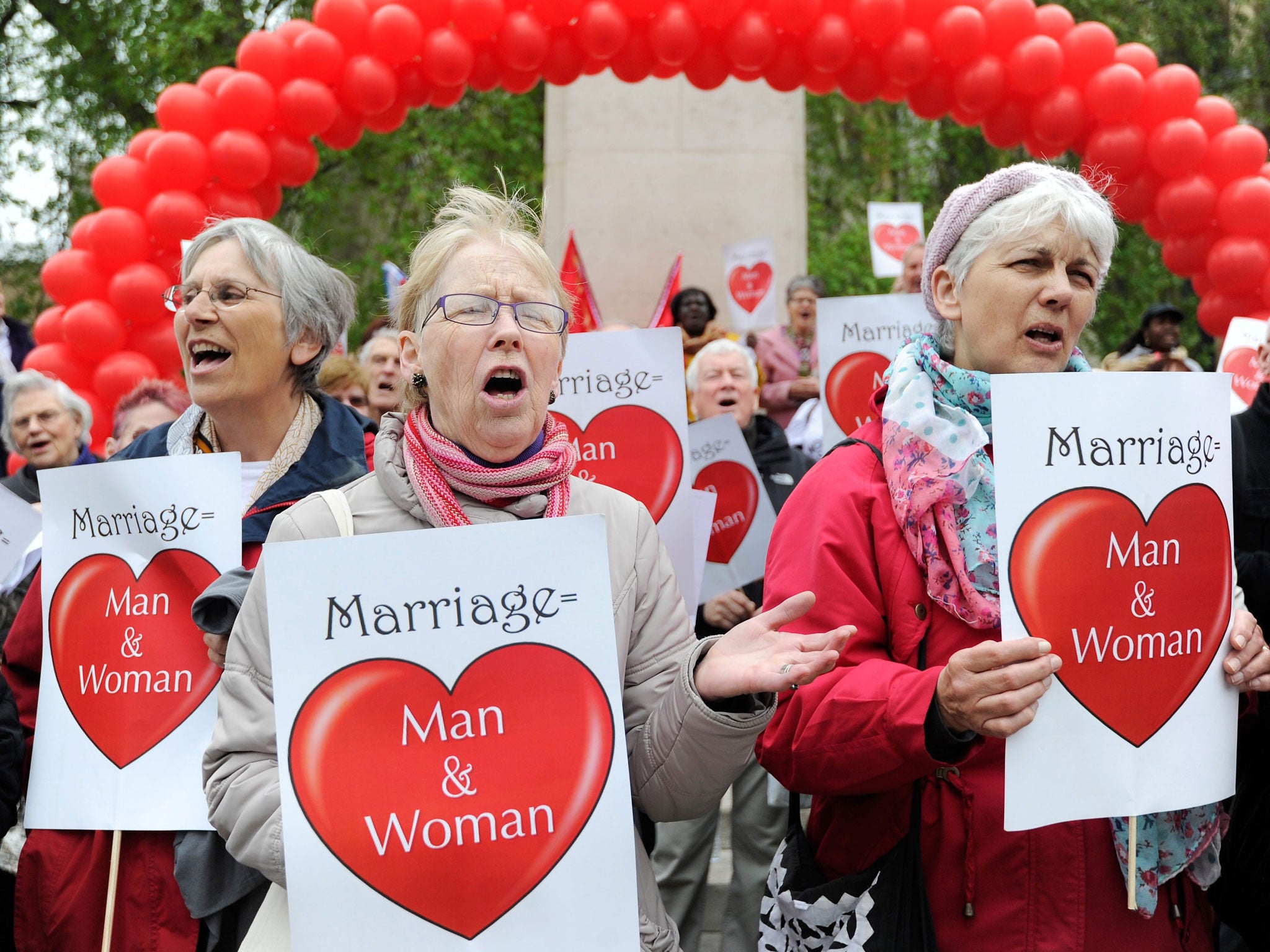 Anti-same sex marriage activists demonstrate outside the Houses of Parliament in London