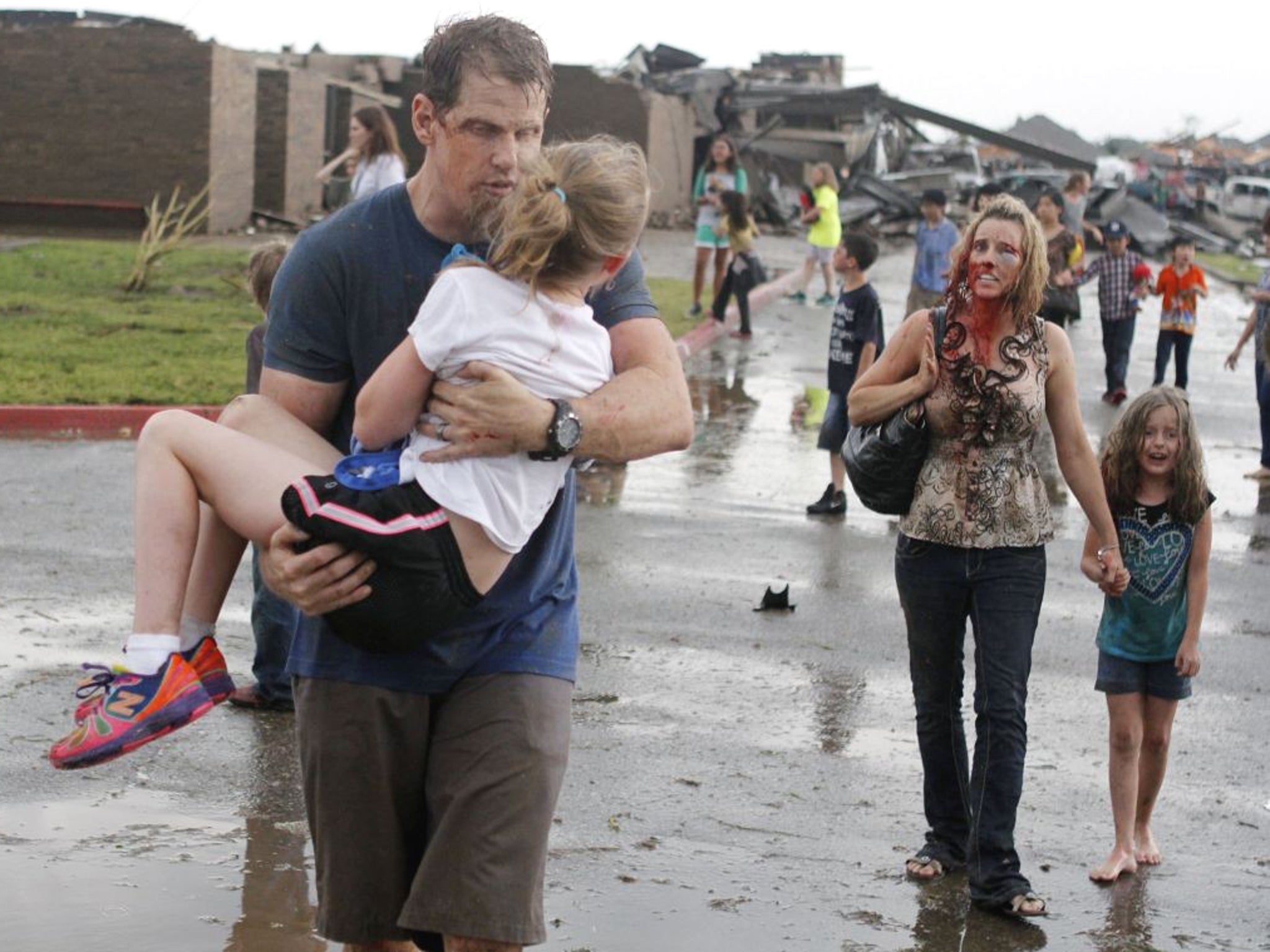 The image of the Cobb family staggering out of Briarwood Elementary school featured on front pages of newspapers across the world