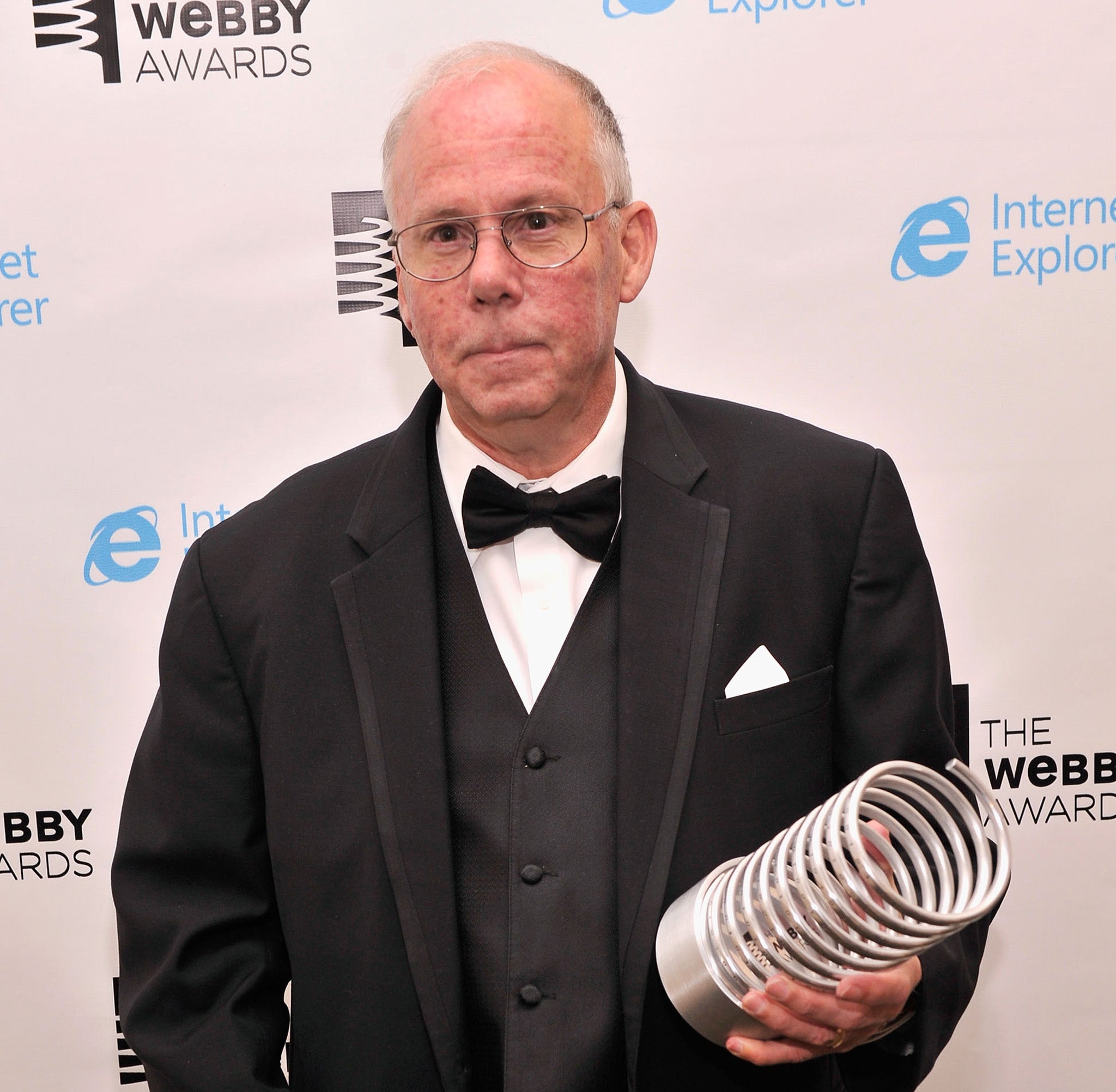 Steve Wilhite, inventor of the GIF file, poses with an award backstage at the Webby Awards. He says the file should be pronounced 'jif' not 'gif' with a hard 'G'.