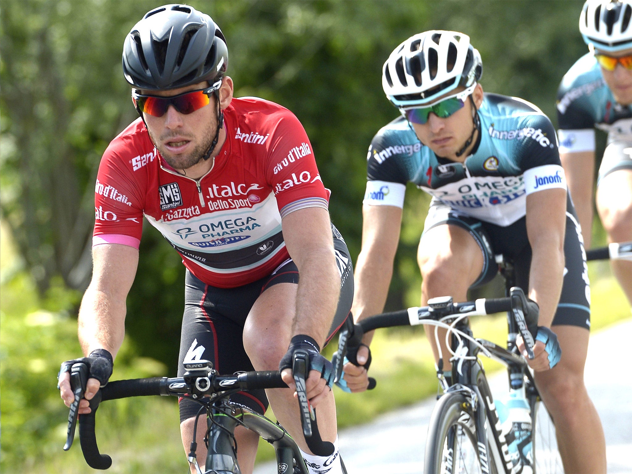 Mark Cavendish (left) tries to keep up in the points leader’s red jersey yesterday