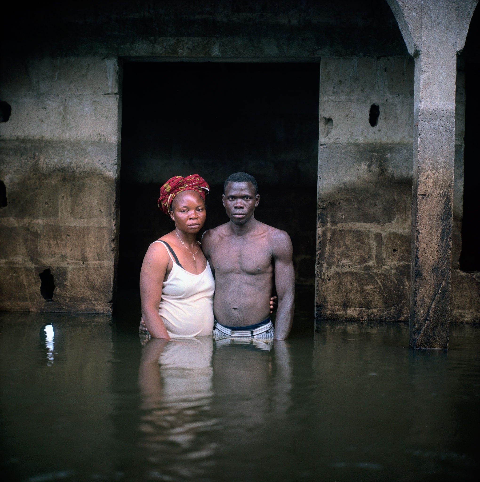 Victor and Hope America pose for a portrait waist-deep in water at their home in Bayelsa State, Nigeria, 2012