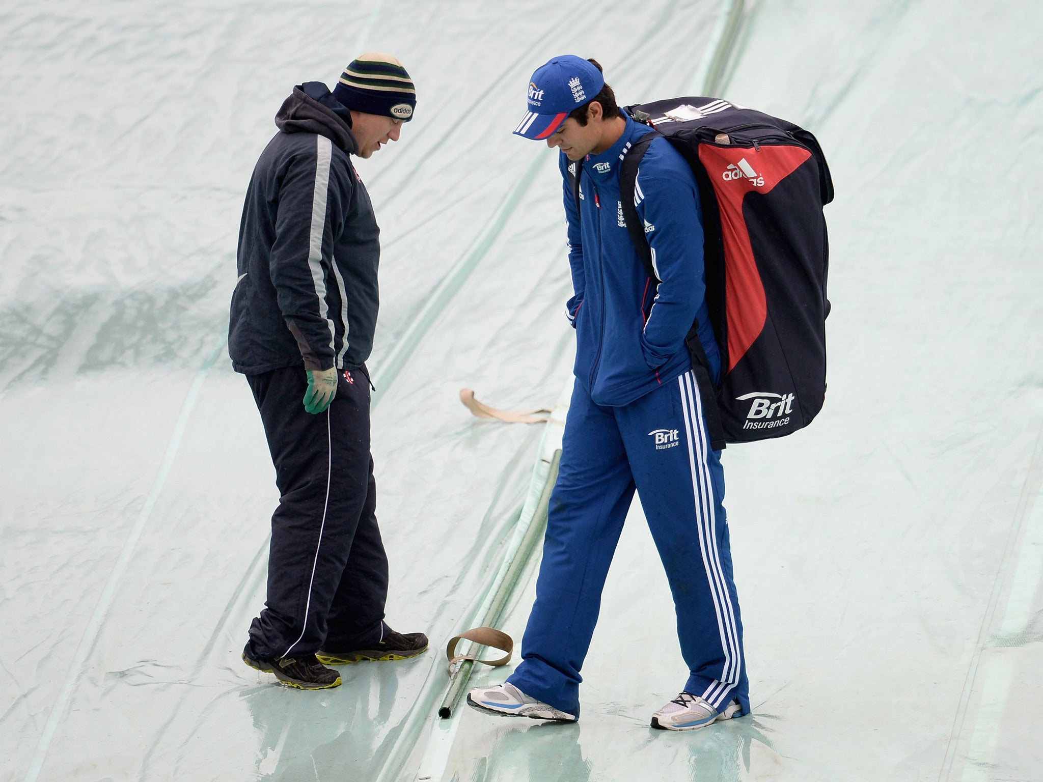 England captain Alastair Cook speaks with groundsman as rain delays play on day one of 2nd Investec Test match between England and New Zealand at Headingley