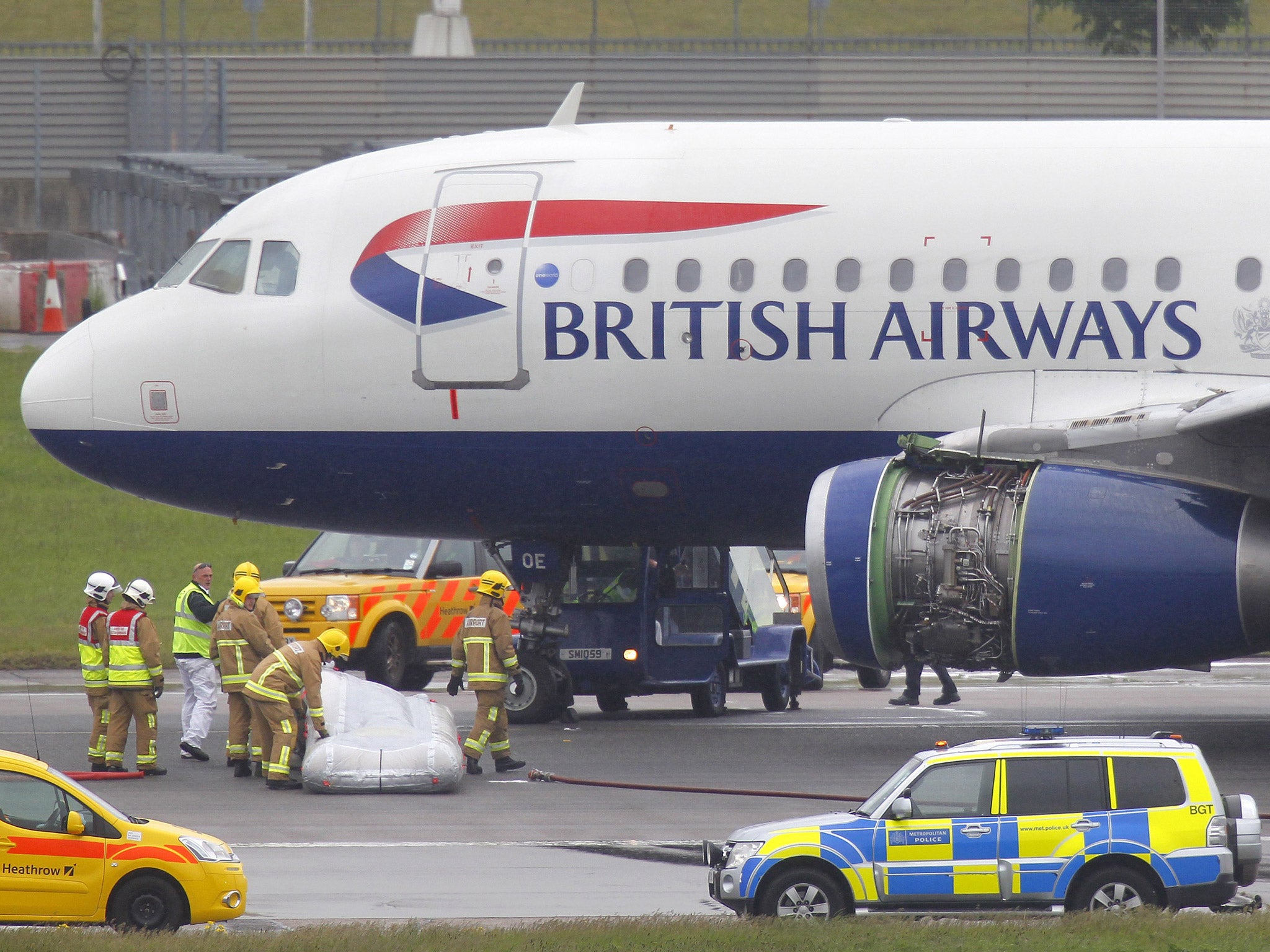 Emergency services attend a British Airways passenger plane after it had to make an emergency landing at Heathrow airport