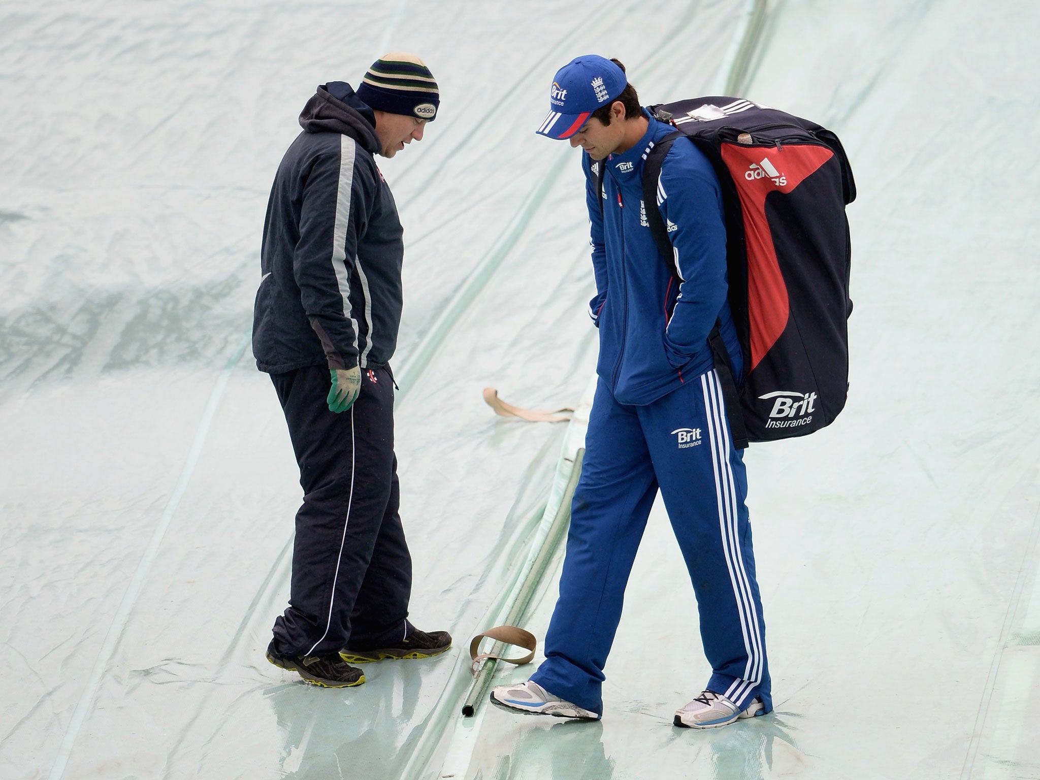 England captain Alastair Cook speaks with a Leeds groundsman