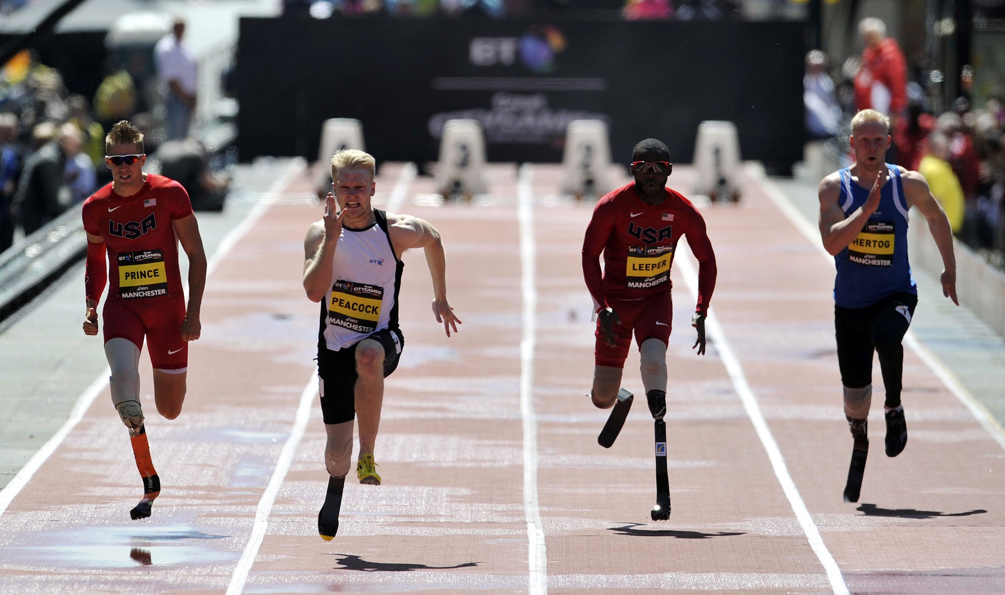 Here’s Jonnie: Britain’s Jonnie Peacock (second from left) sprints to victory in the T43/44 100m during the Great CityGames in Manchester yesterday