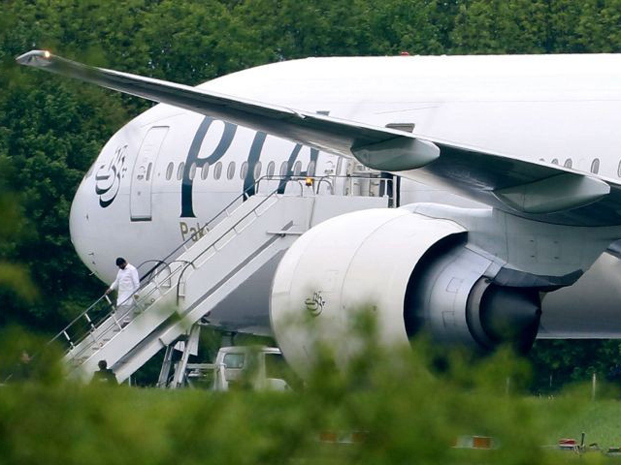 Passengers disembarking Pakistan International Airlines flight PK709 bound for Manchester from Lahore, at Stansted Airport, Essex