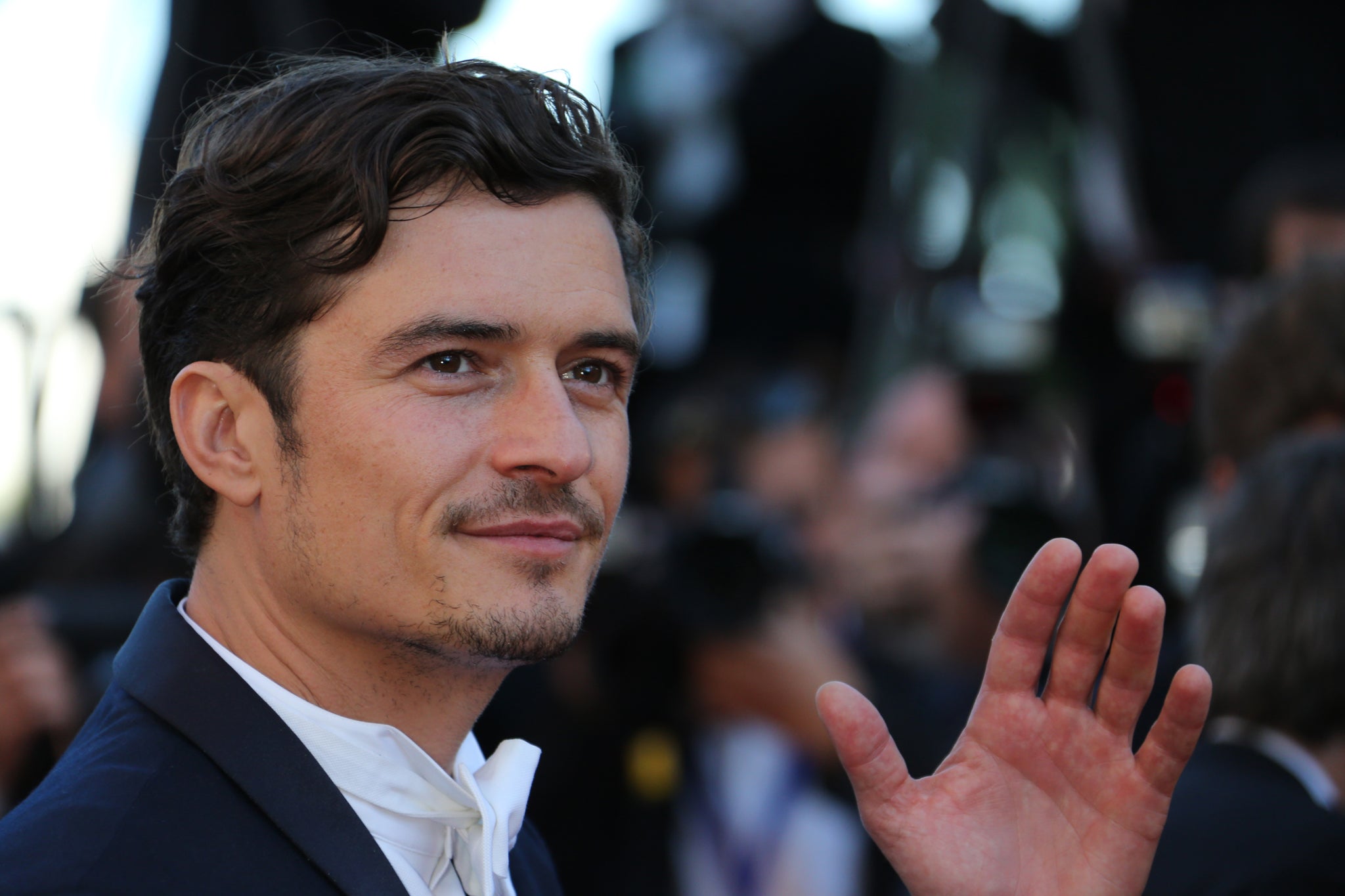 British actor Orlando Bloom waves on May 26, 2013 as he arrives for the screening of the film 'Zulu' presented Out of Competition at the 66th edition of the Cannes Film Festival in Cannes.