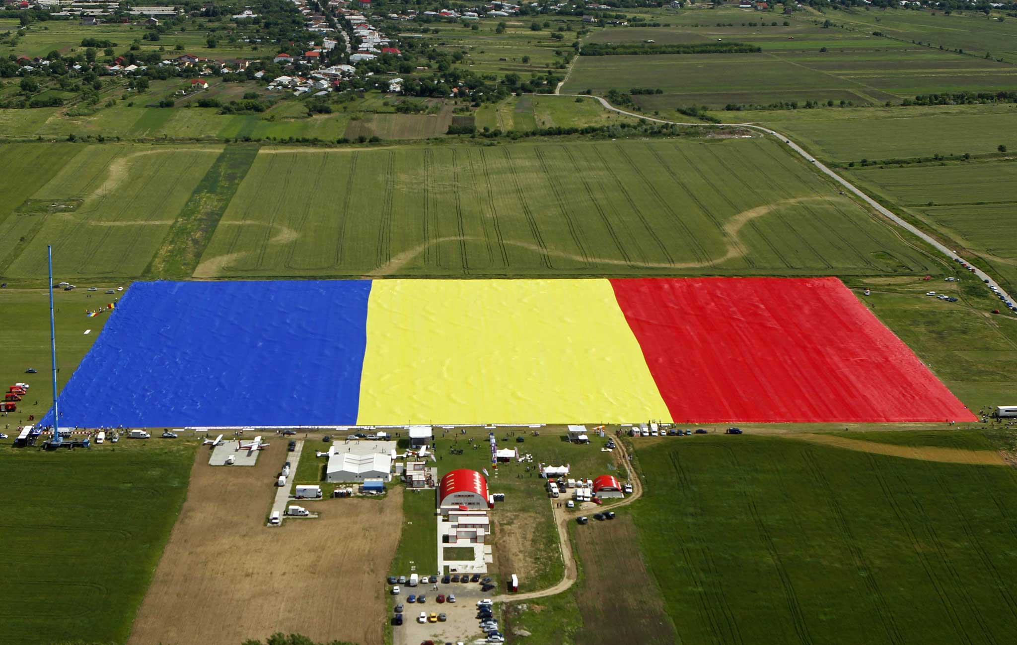 Villagers in Clinceni, Romania, have today covered a field with what they claim is the world's biggest ever flag