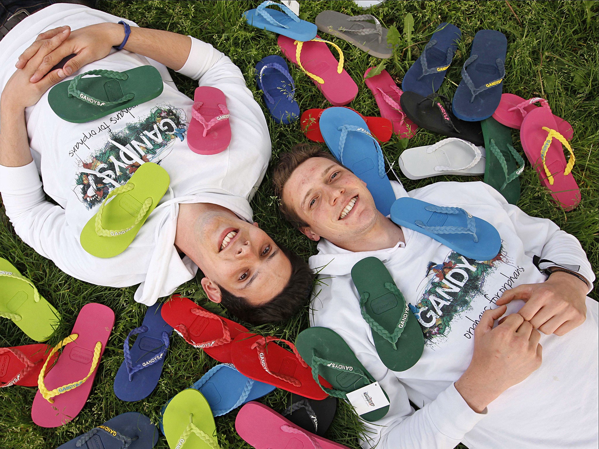 Finding their feet: Rob (left) and Paul Forkan with the flip-flops they sell for their charity