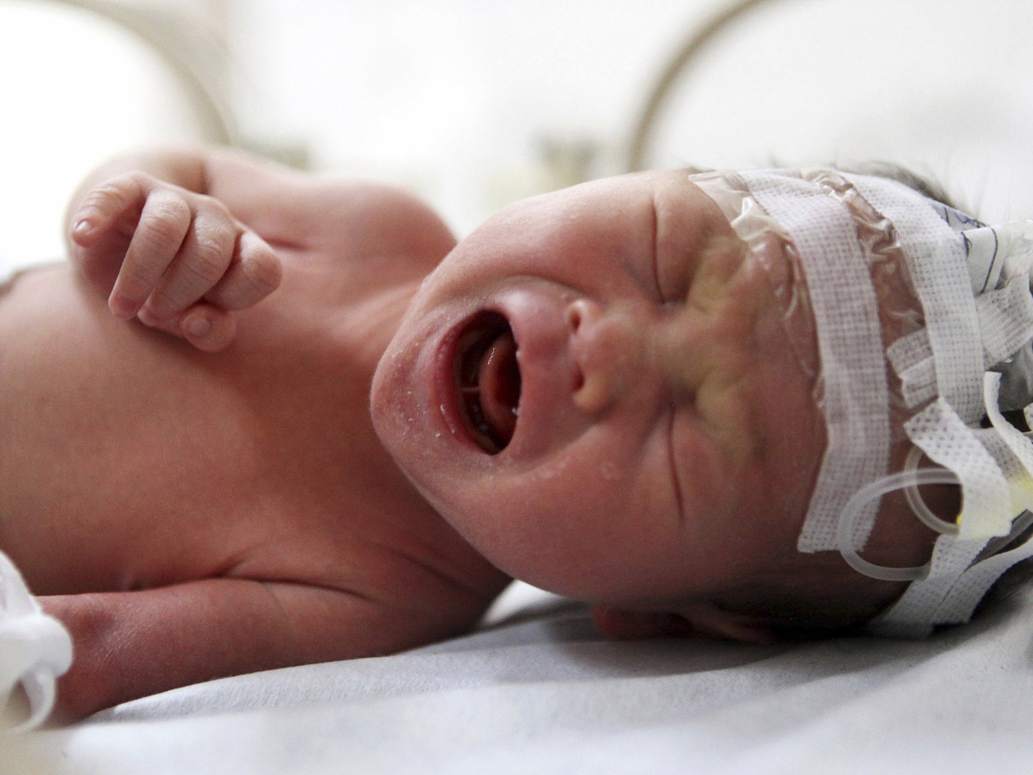 29 May 2013: An abandoned newborn baby cries in an incubator after he was rescued from a sewage pipe at a hospital in Jinhua, Zhejiang province