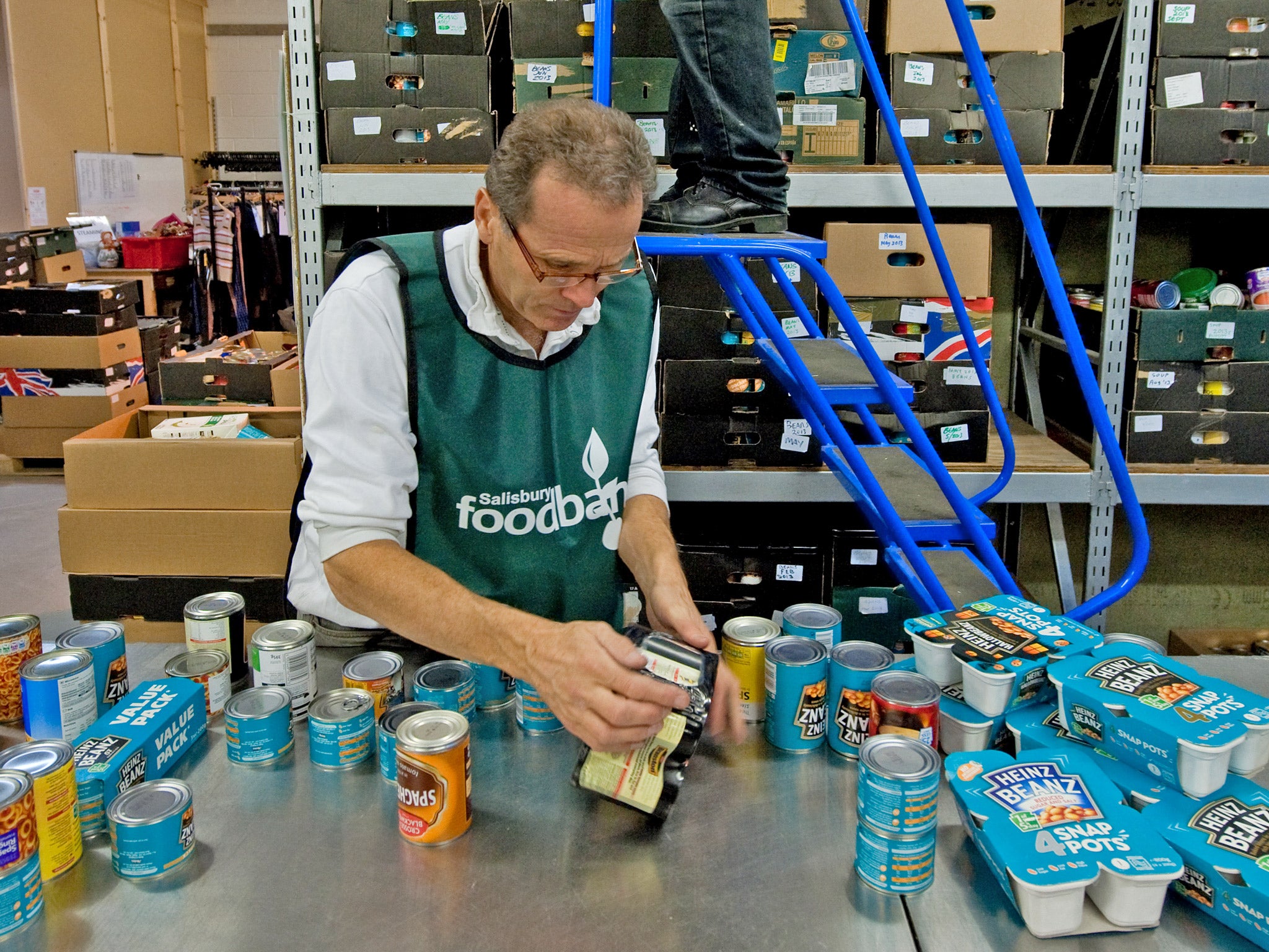 A volunteer at a Trussell Trust food bank sorts donations to the charity in Salisbury, Wiltshire