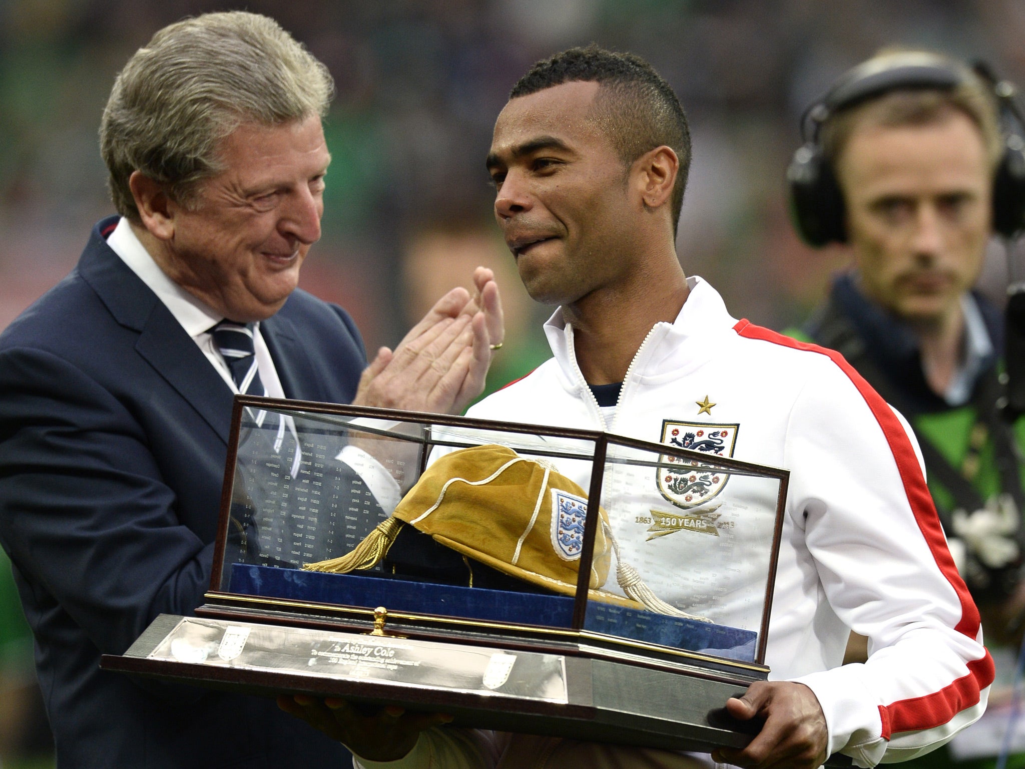 England manager Roy Hodgson applauds as England defender Ashley Cole is presented with a golden cap in recognition of 100 caps for the national team