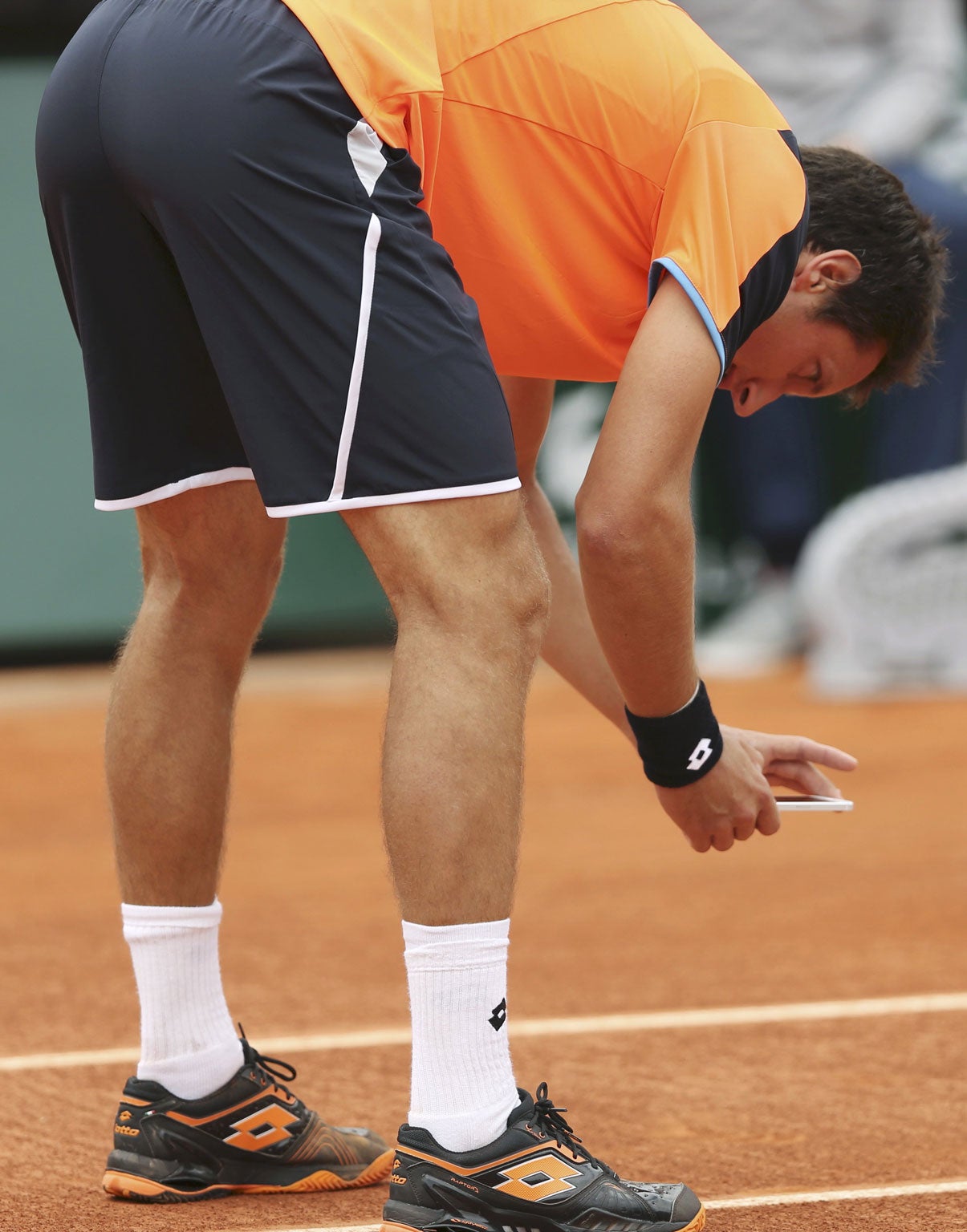 Snap judgement: Sergiy Stakhovsky takes a photo of a disputed ball-mark